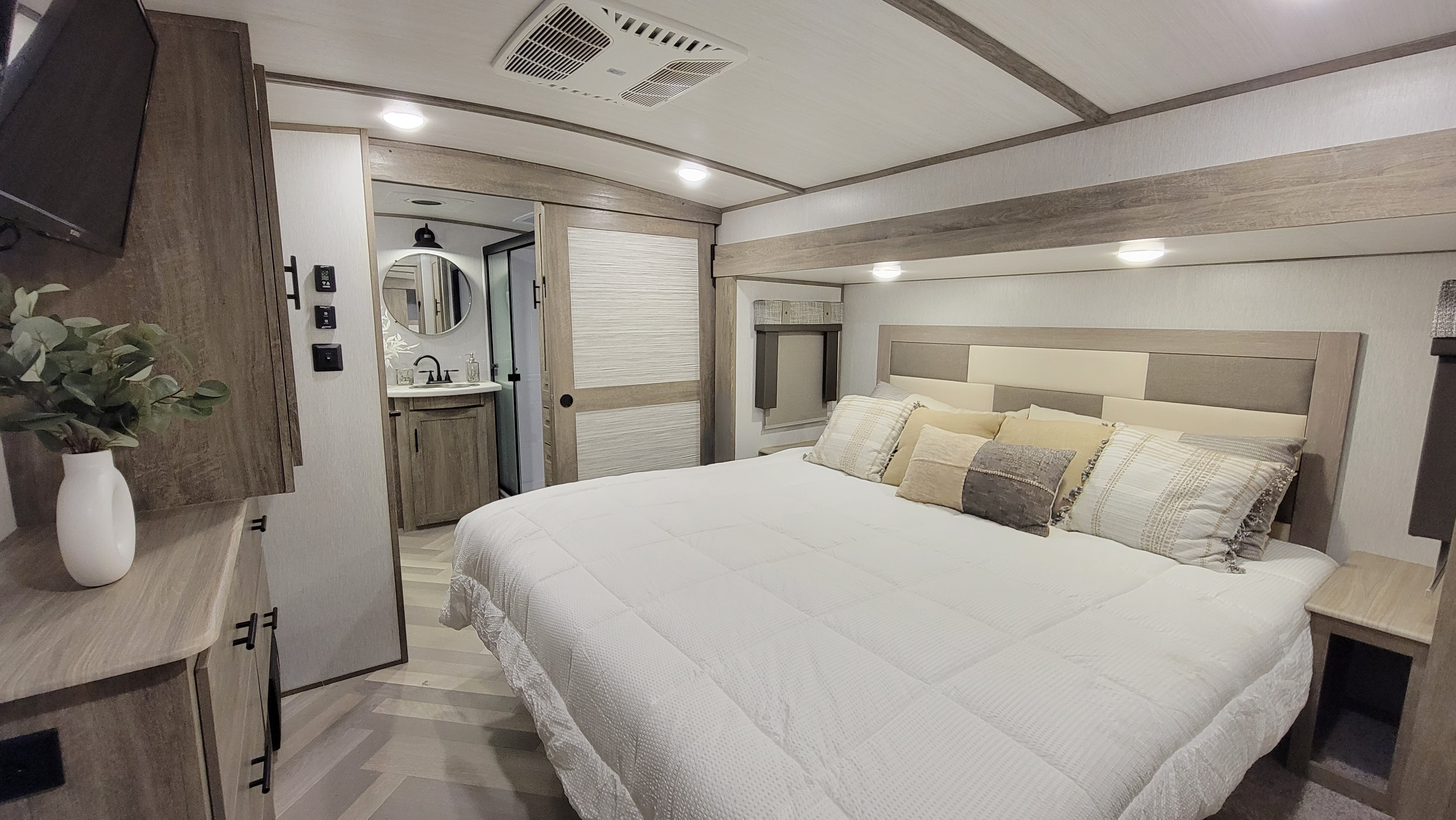 Spacious master bedroom with a comfortable king size bed with a 3 inch foam mattress topper.. Forest River Wildwood Heritage Glen 2022