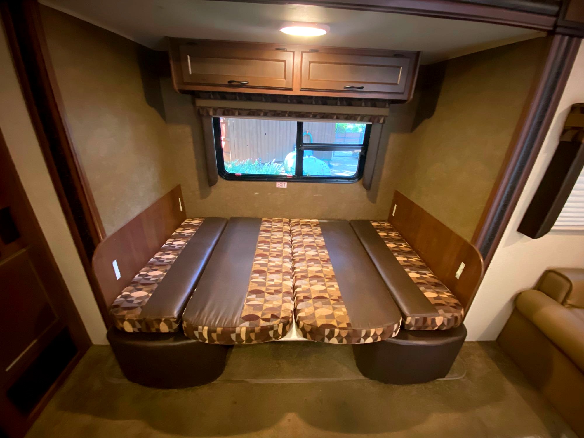 Spacious RV rental interior: A dinette area with brown patterned cushions, ready to convert to a comfy bed.. Jayco Jay Flight 2015