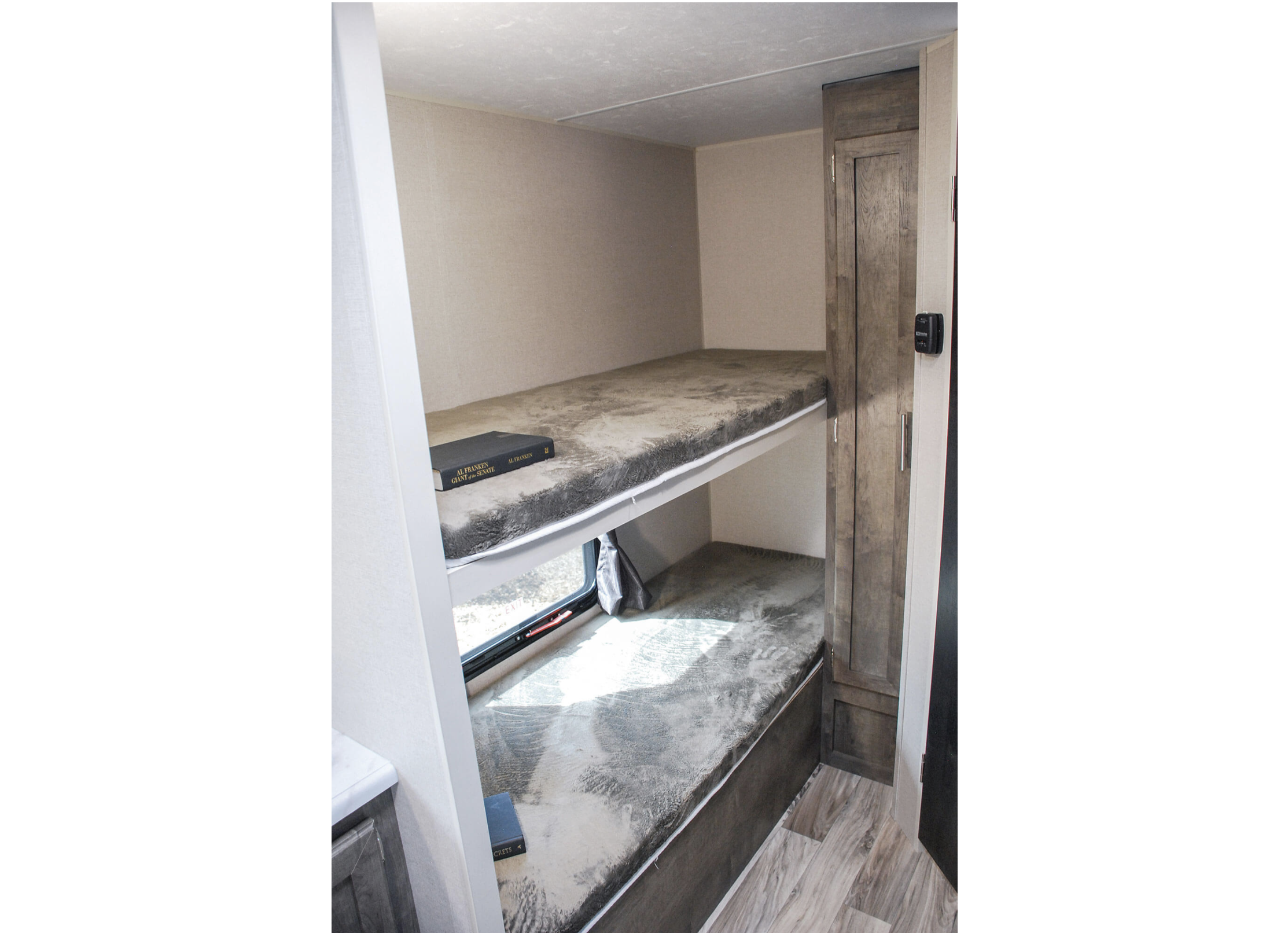 Cozy RV rental bunk beds provide comfy sleeping space, perfect for family travel. This RV interior features compact living.. KZ Escape 2020