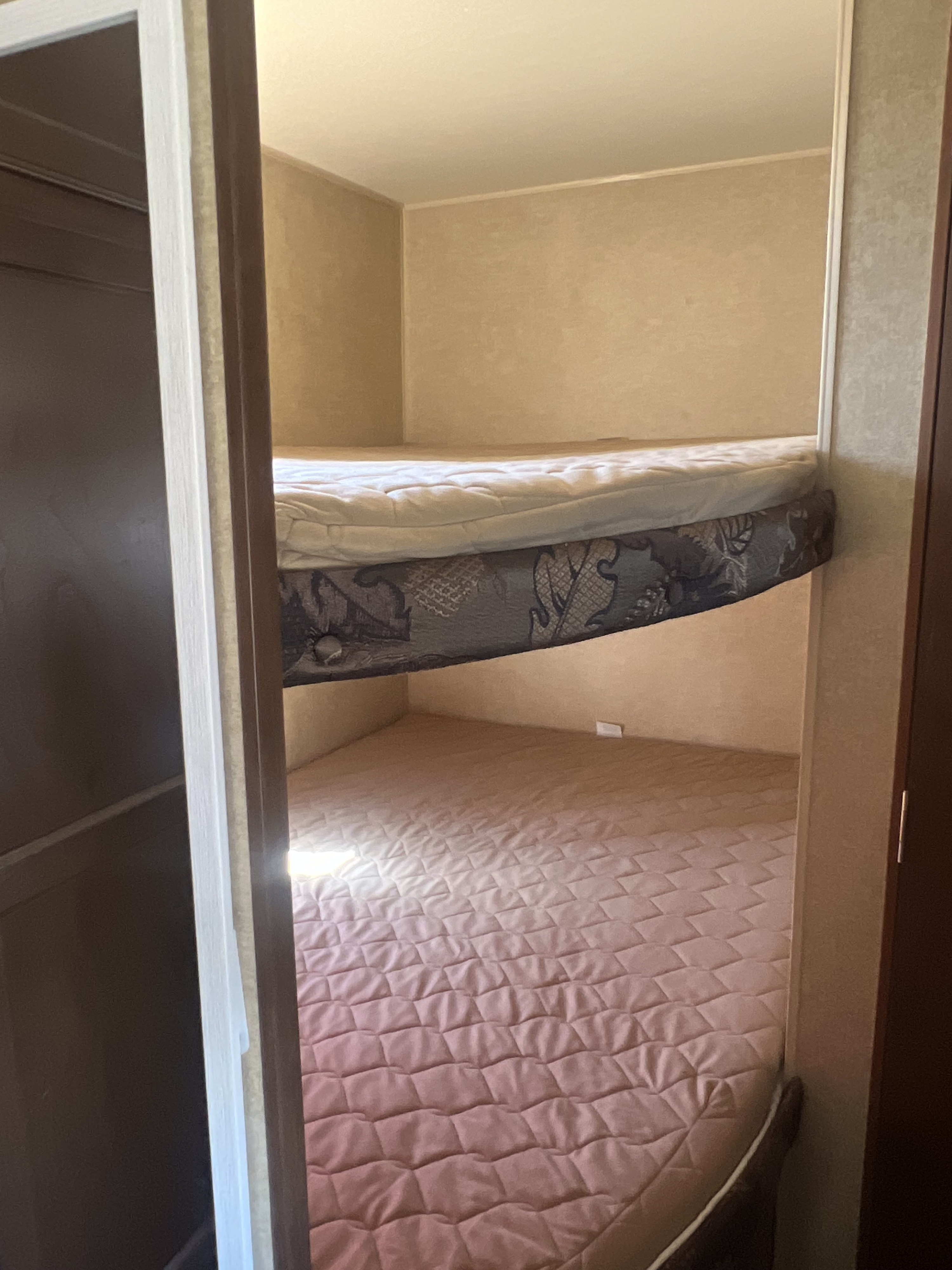 Inside an RV rental, two bunk beds offer cozy travel accommodation.. Jayco Jay Flight Swift 2014