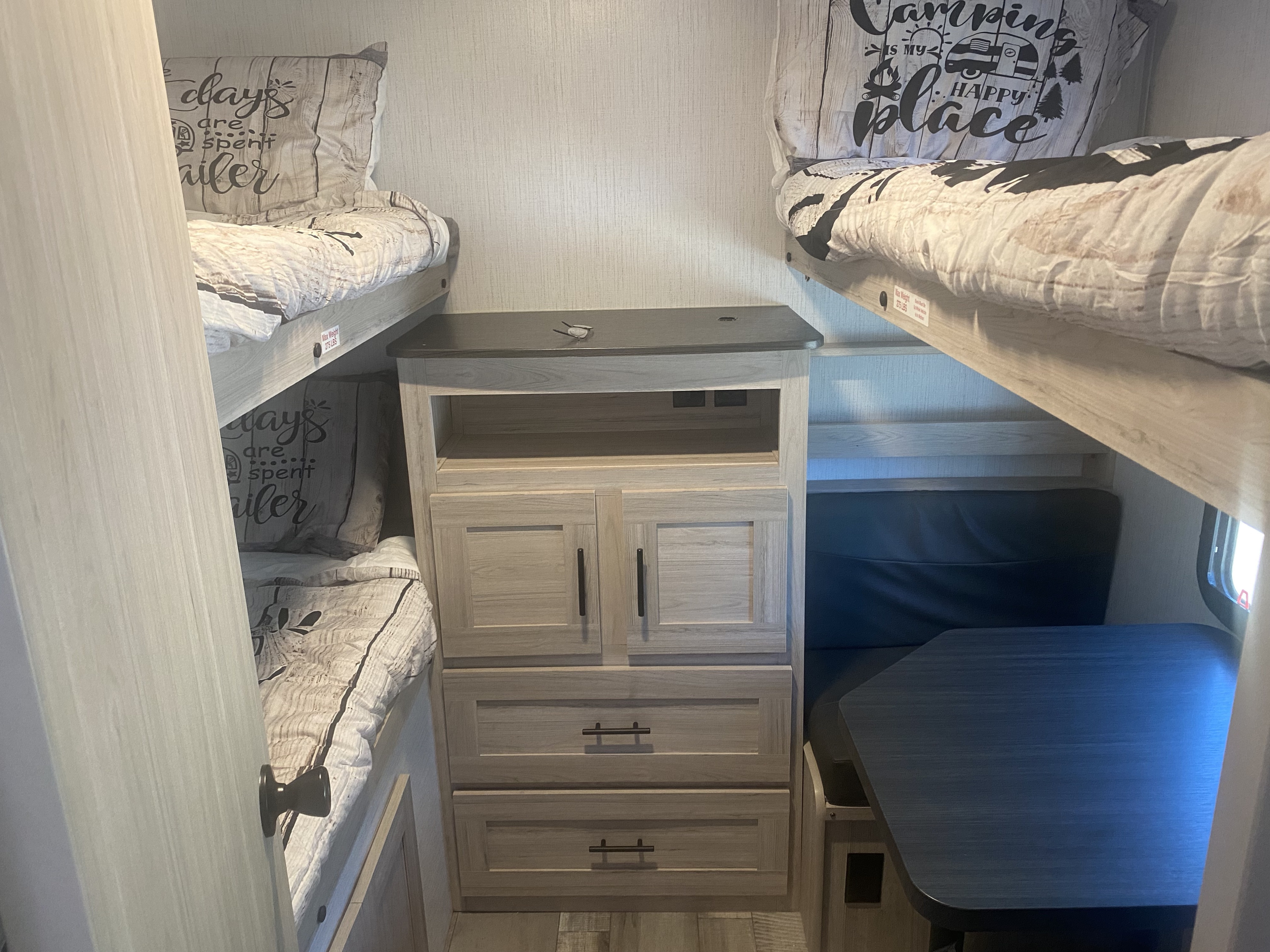 Cozy RV rental interior featuring bunk beds, a compact dinette, and built-in storage for comfortable travel.. Heartland RVs Sundance Ultra Lite 2022