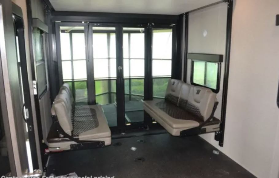 RV rental: Versatile RV interior with durable floor, fold-up benches, and large rear patio doors for flexible use.. Grand Design Momentum 2022