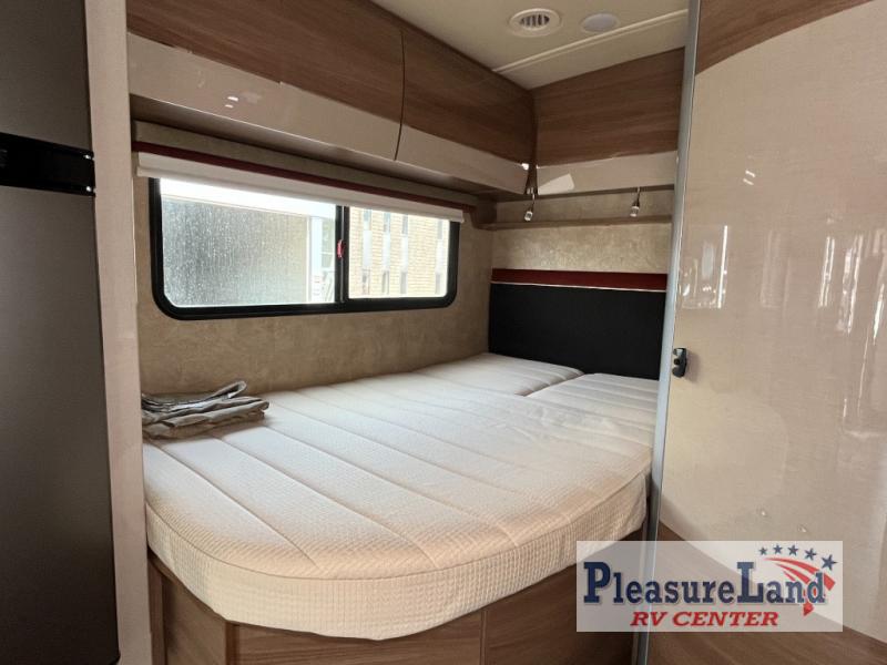 Cozy motorhome bedroom for your next RV rental adventure, featuring a comfortable bed and overhead storage.. Winnebago View 2017