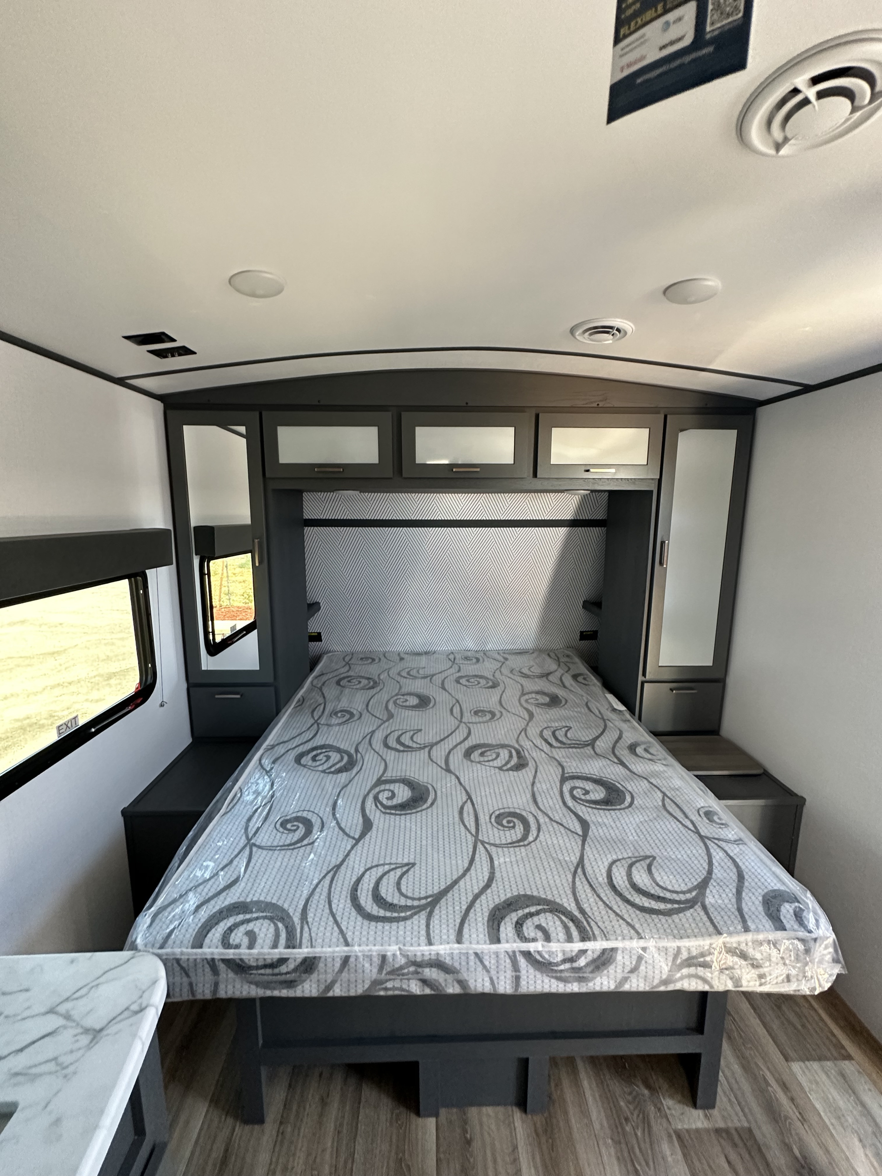 Modern RV rental bedroom with a large bed, built-in cabinets, side wardrobes, and ambient lighting, maximizing space for travelers.. Keystone RV Bullet Ultra Lite 2023