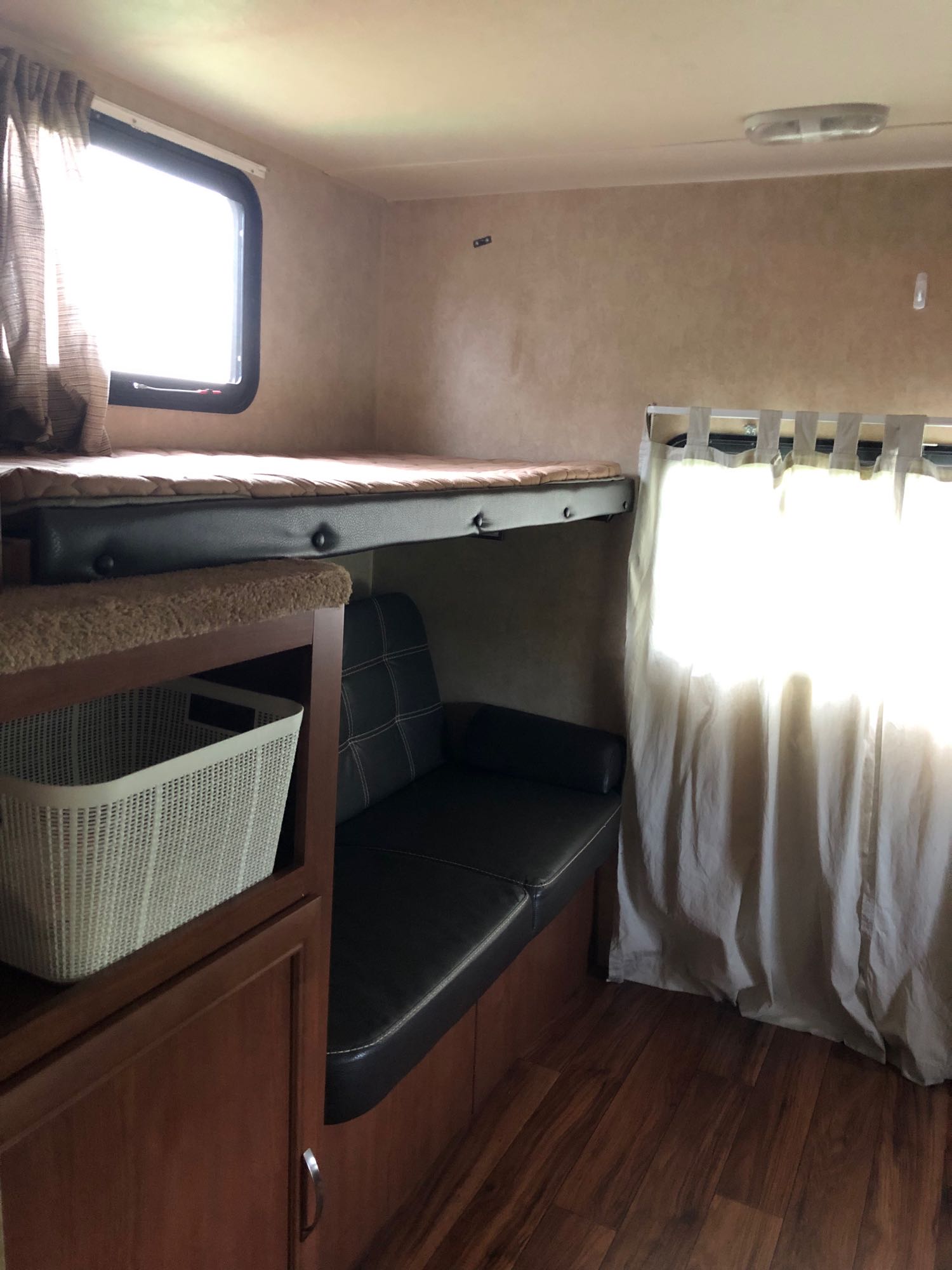 RV rental interior featuring bunk beds, a sofa, and built-in storage, creating a cozy living space.. Forest River Salem 2016