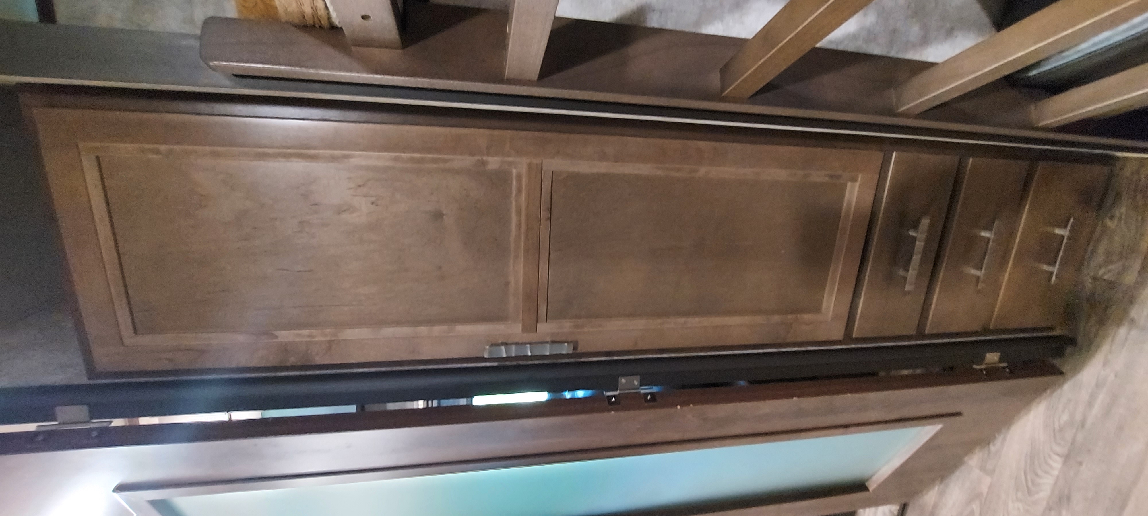 RV rental: Brown wood cabinetry features two large doors and three drawers, providing practical storage within this RV.. Highland Ridge RV Mesa Ridge 2019