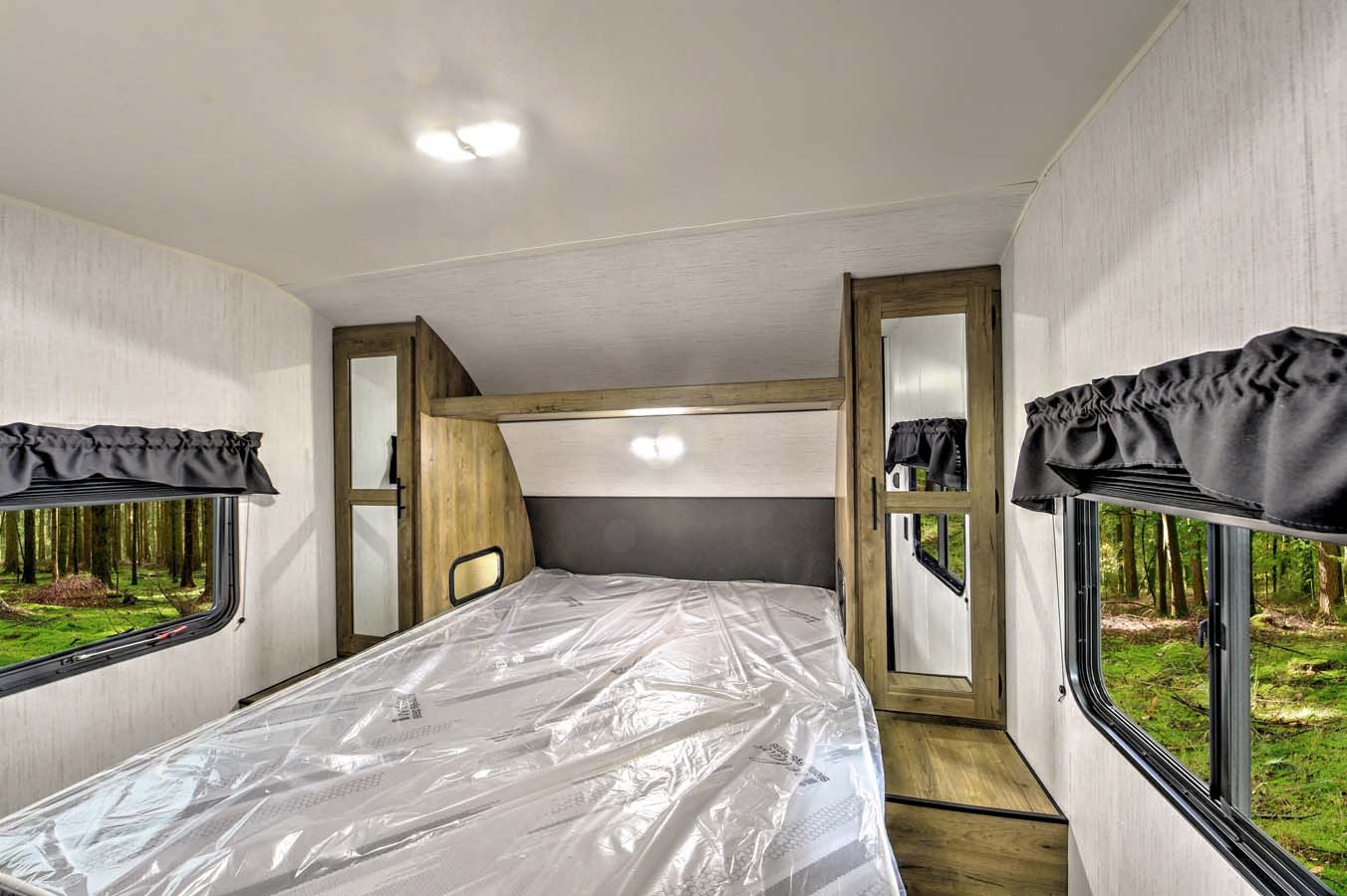 Queen bed. Each nightstand has outlet and light. Roomy storage!. Heartland RVs Pioneer 2023