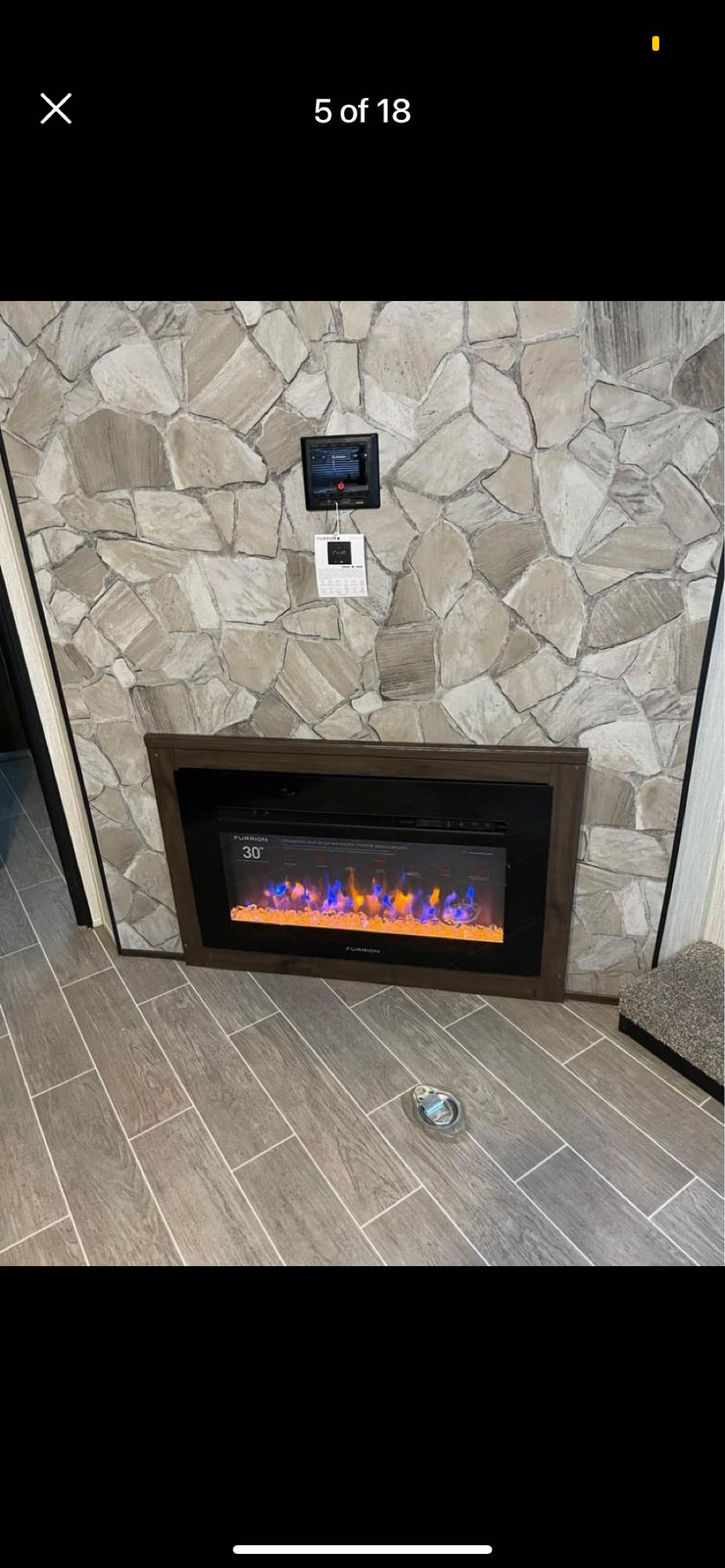 Explore this RV rental's cozy interior: Furrion electric fireplace with colorful flames, digital control, and stone wall.. Forest River Cherokee Grey Wolf 2020