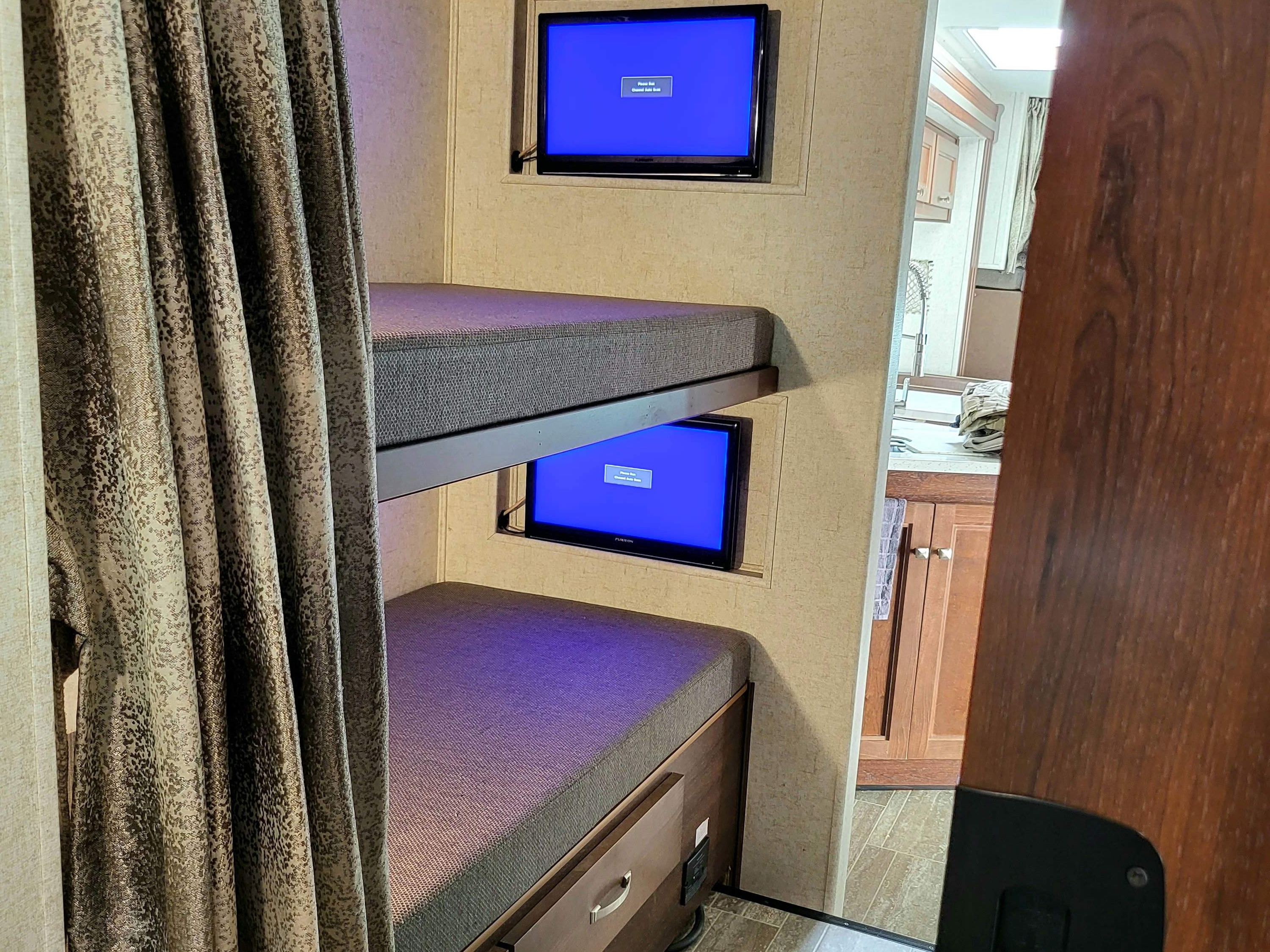 Bunk beds with dual television sets. Forest River Forester 2019