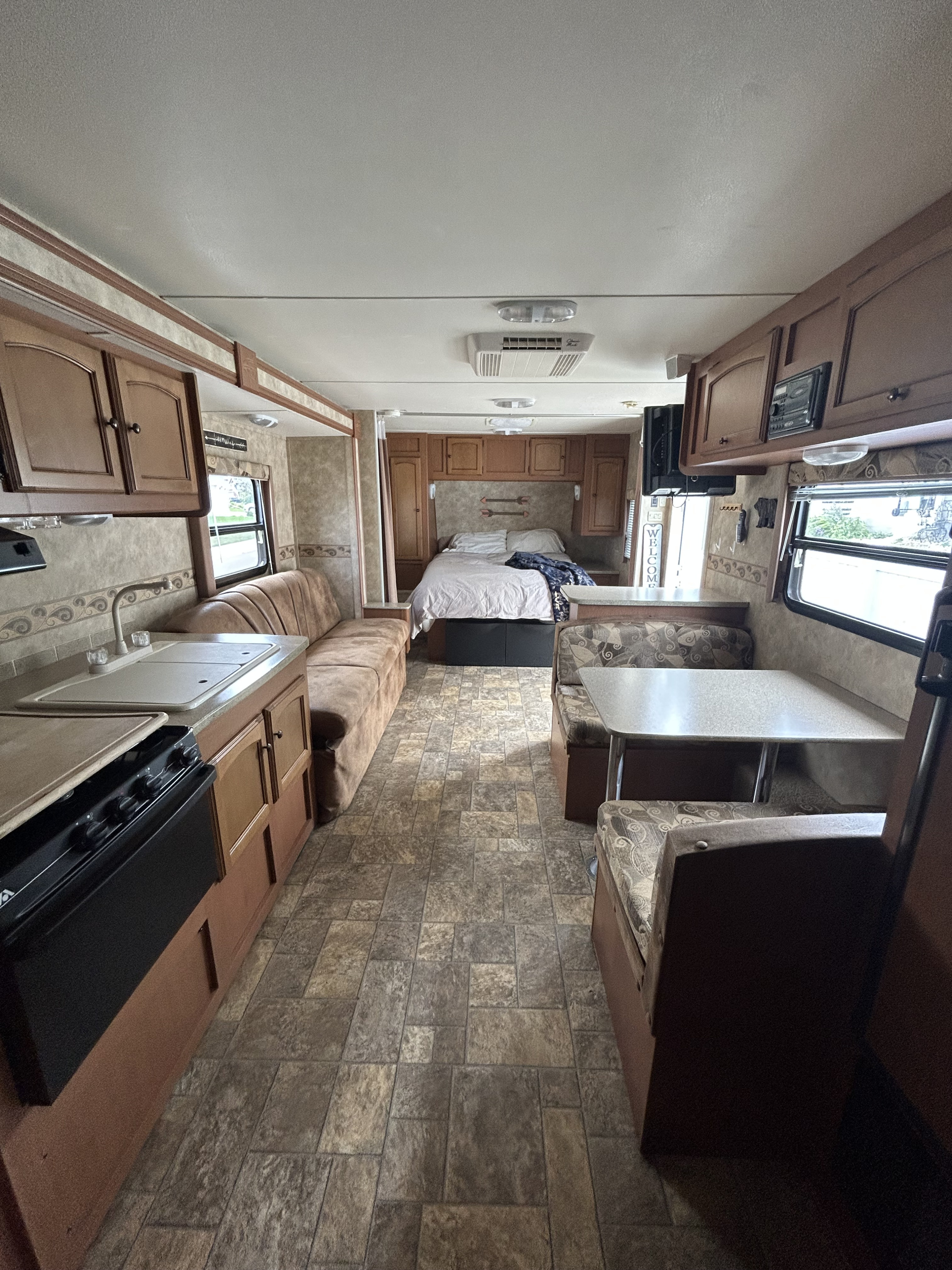 Inside a spacious RV rental: full kitchen, dinette, bed & living area.. Gulf Stream Stream Lite Sport 2011