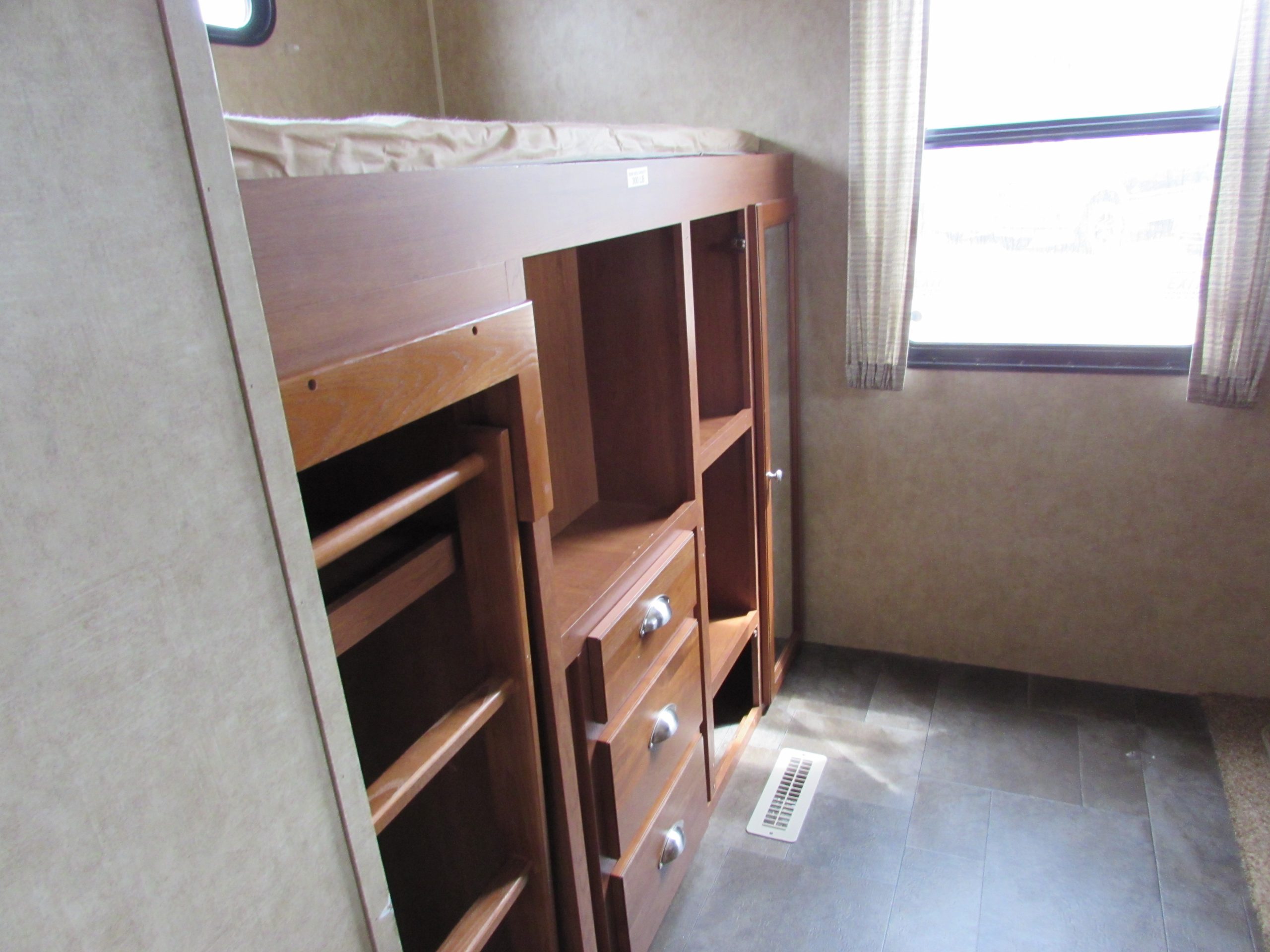 Part 2 of back bunk. Double bed above closet and storage area. Hook up for TV (available at cost), perfect for movies on rainy days.. Dutchmen Coleman Expedition LT 2013