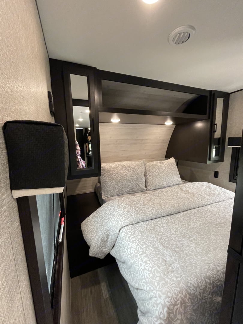Modern RV rental bedroom with a cozy bed, ample storage, and accent lighting, ideal for relaxing trips.. Jayco Jay Flight Baja Edition 2023