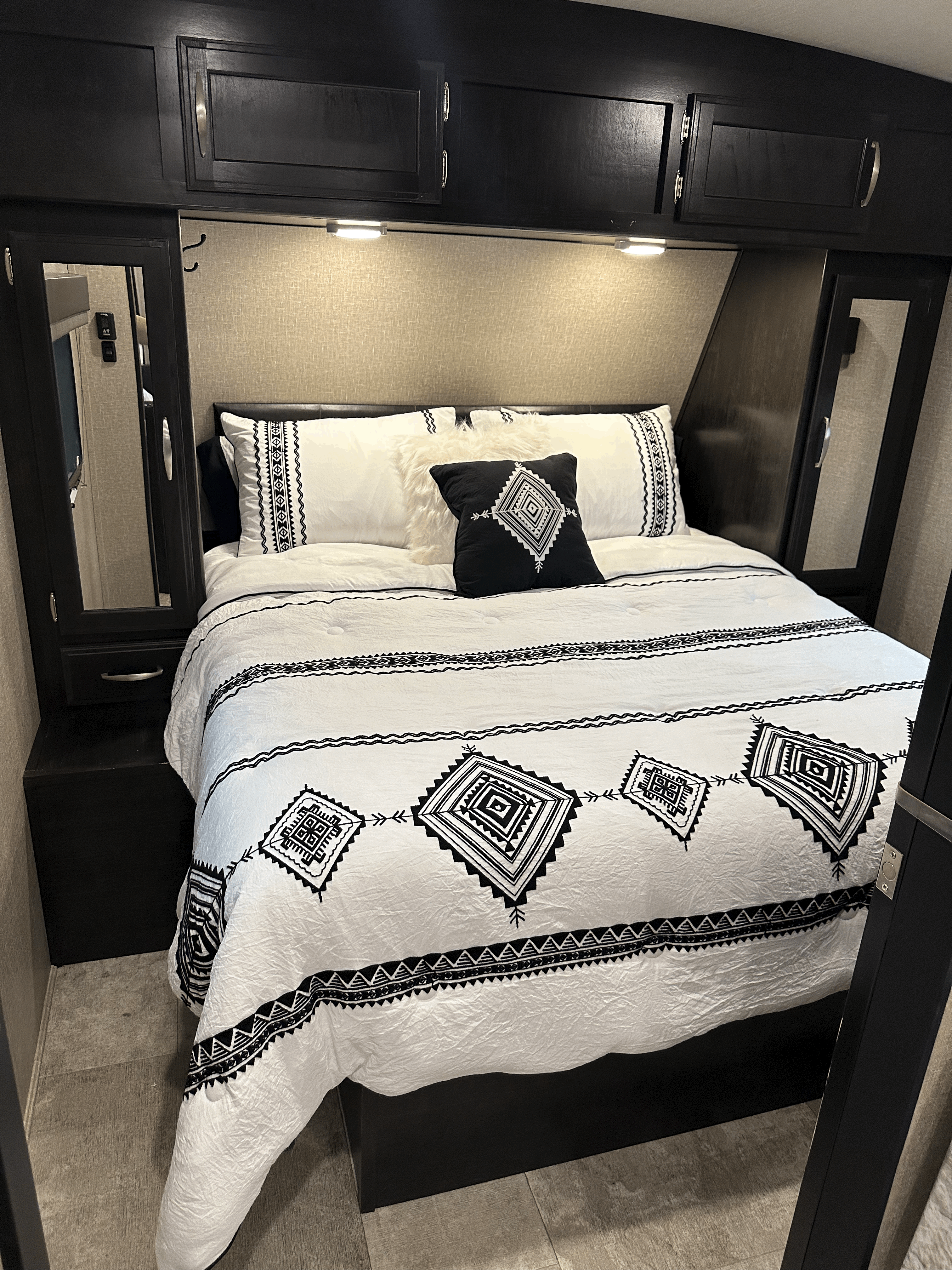 Queen bed w/upgraded mattress & bedding. Mattress is a hybrid spring coil w/ 4" memory foam. Cabinets are empty, bed lifts for storage underneath.. Grand Design Imagine 2019