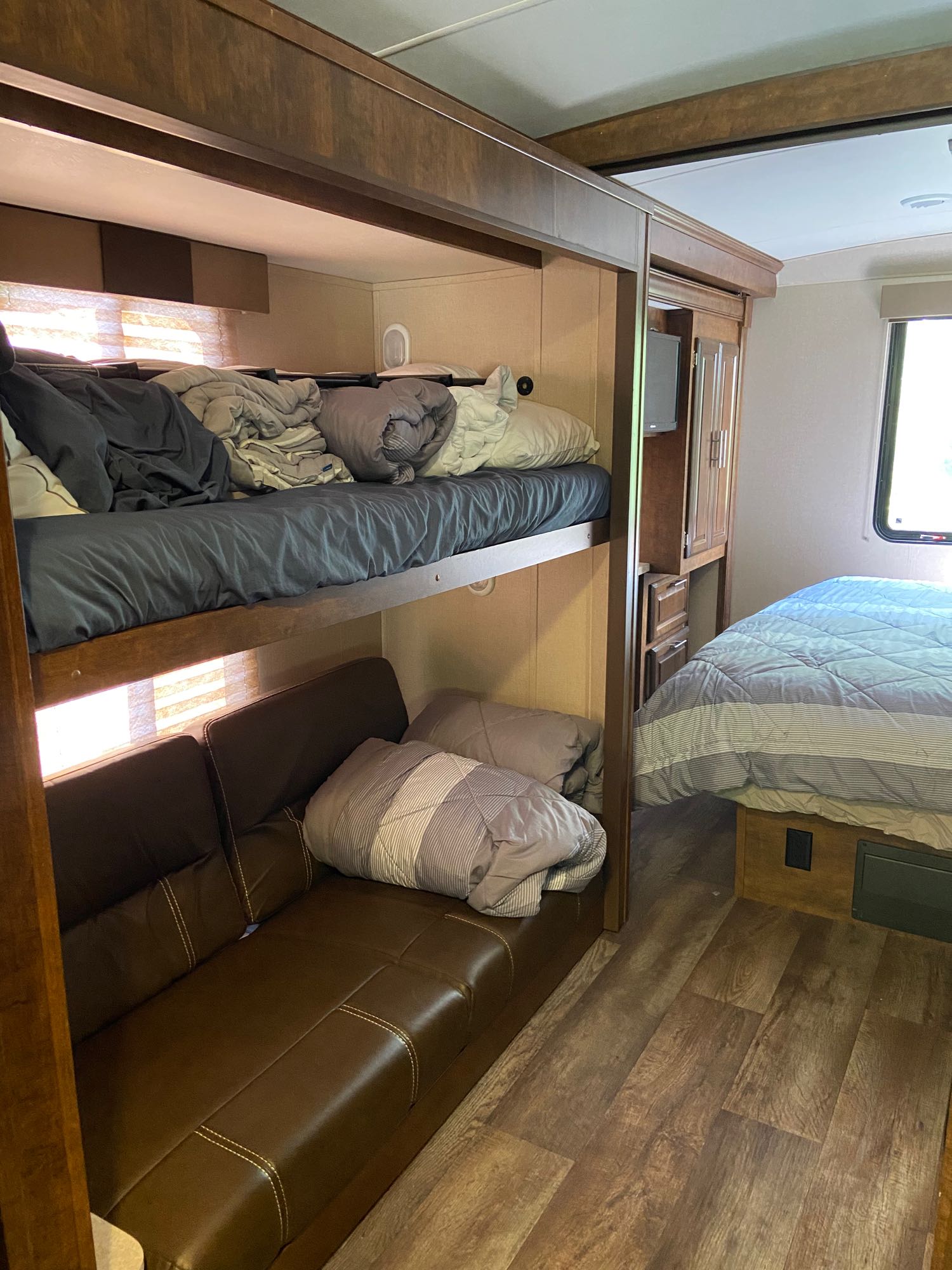 RV rental: Compact interior showing bunk beds, a sofa, and a master bed, optimized for comfortable mobile living.. Forest River Fr3 2017
