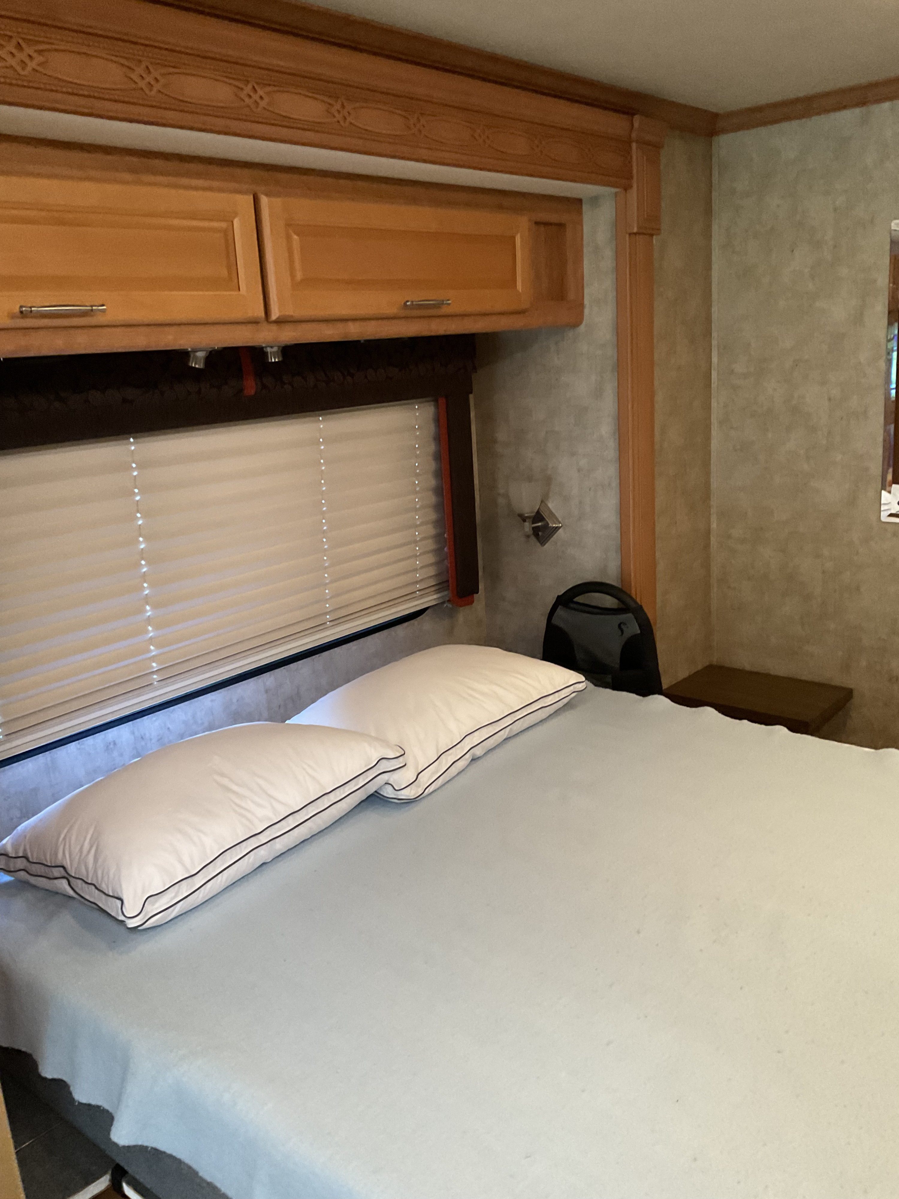 Enjoying lakeside views and outdoor living with an RV rental, featuring an extended awning, picnic table, and scooter.. Fleetwood Southwind 2009