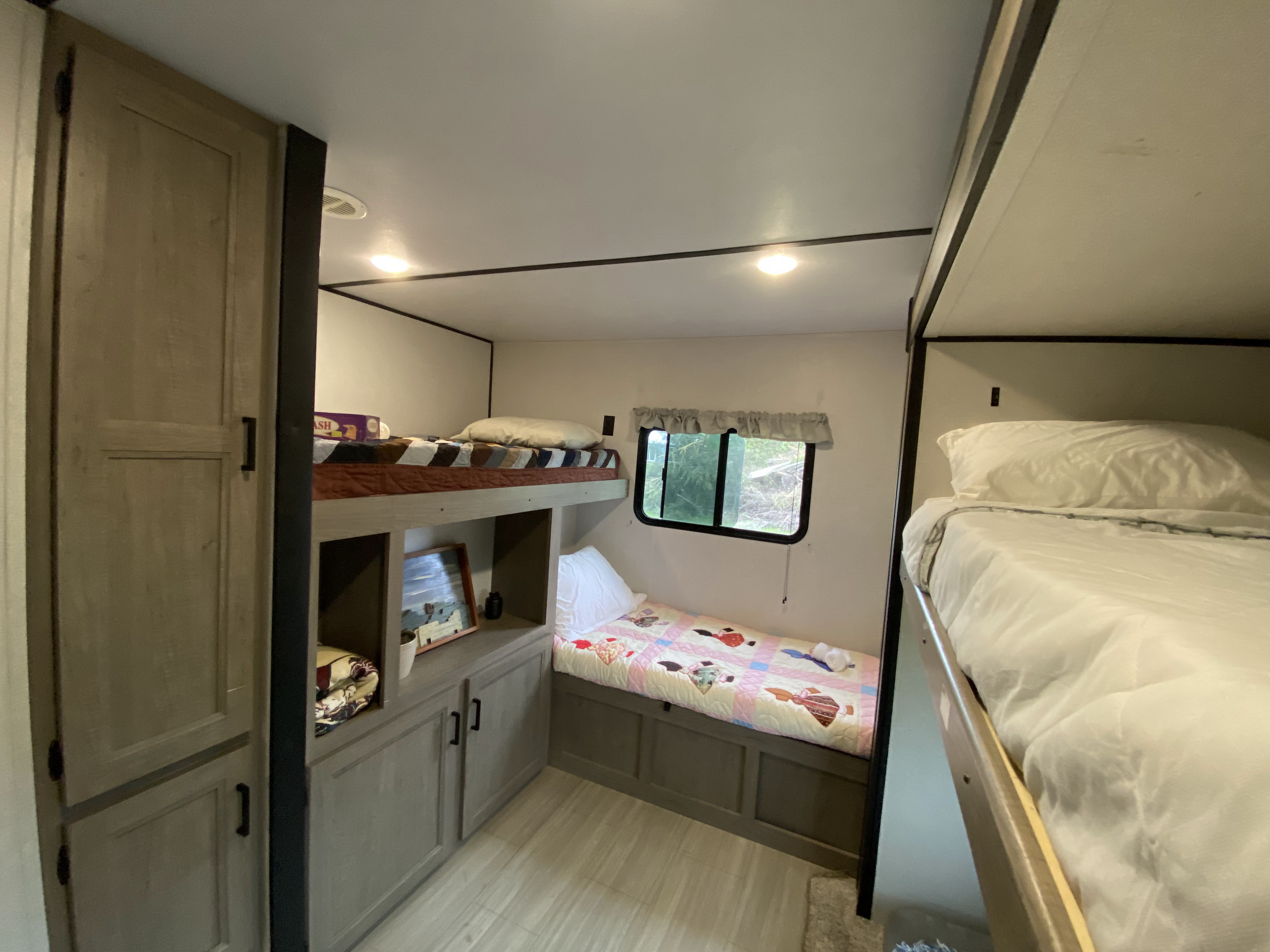 RV bunk bed area: three comfortable beds, storage, and a window in this RV rental.. Keystone Hideout 2021