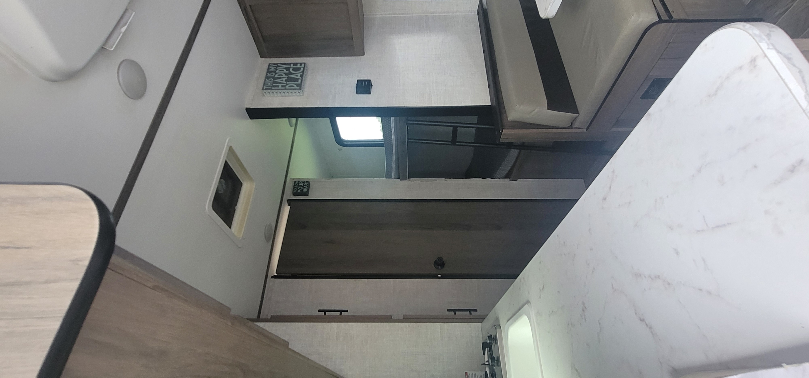 Empty shot of the sink towards the bunks and bathroom. Gulf Stream Enlighten 2021