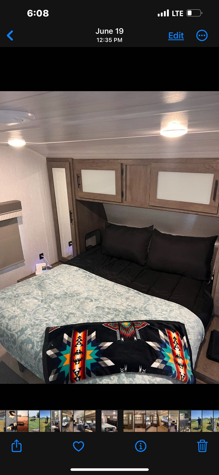 Cozy RV rental bedroom featuring a comfy bed with Southwestern blanket and ample storage.. Forest River Wildwood 2022
