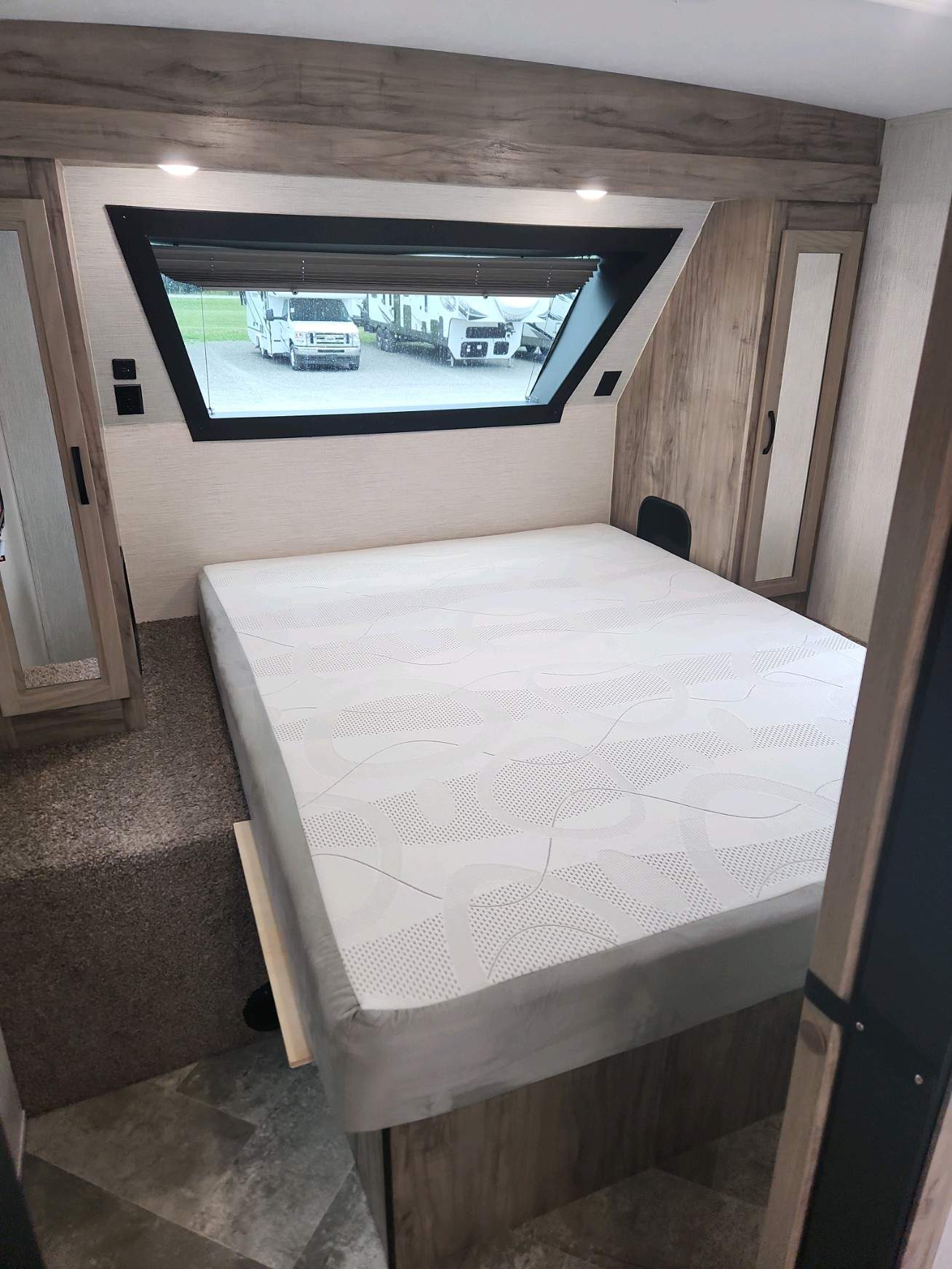 Spacious RV rental bedroom with a comfortable bed, large window, and cozy interior. Perfect for your next adventure.. Palomino Solaire 2022