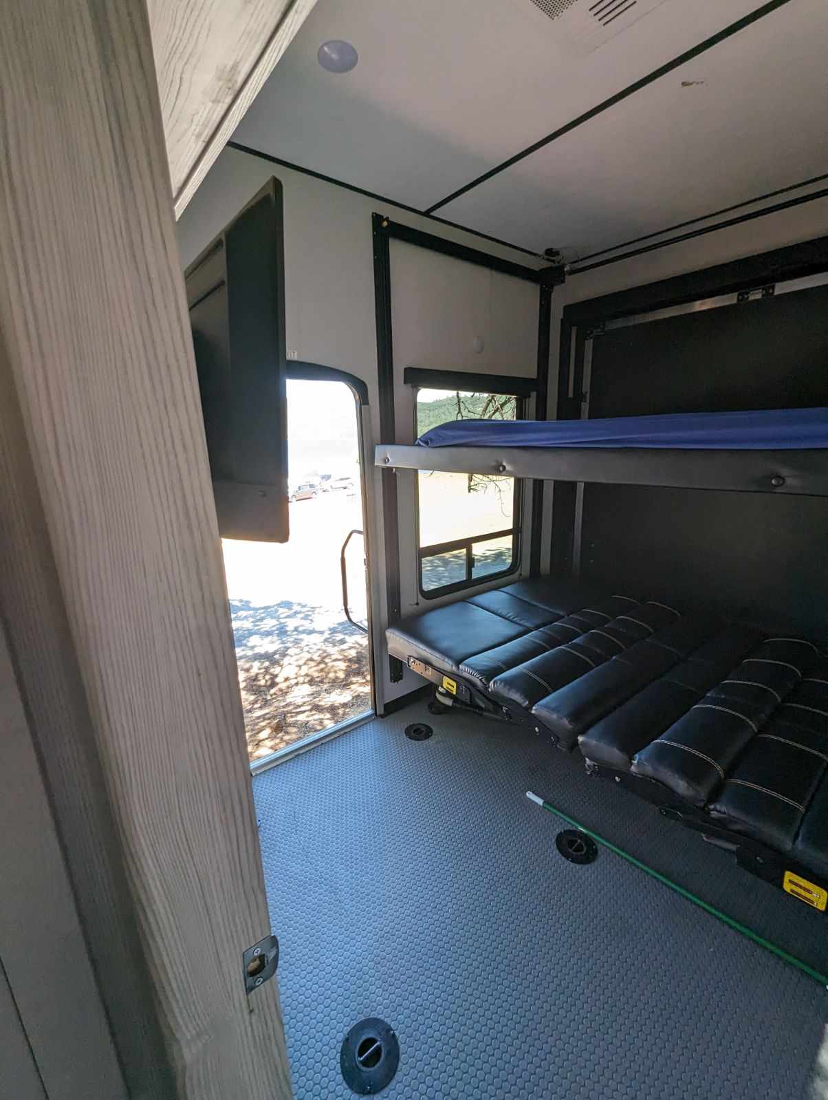 Back garage area with two electric rising beds. Bottom bunk turns into two sofas. . Keystone Fuzion 2022