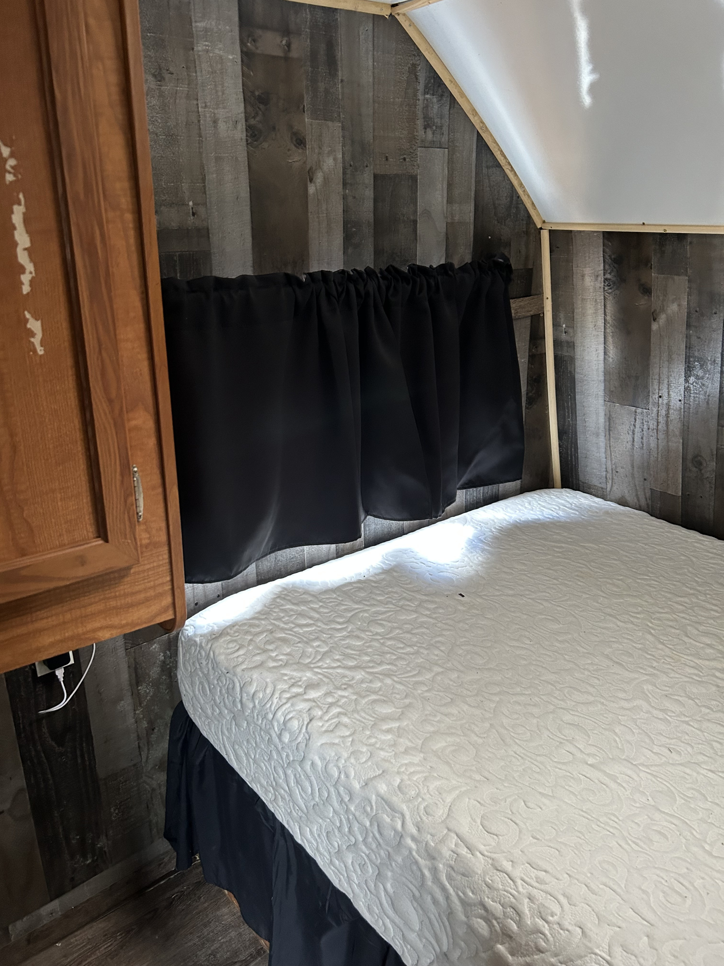 Master bedroom with 12” memory foam mattress and storage closet with blackout curtains. . Coachmen Spirit of America 2005