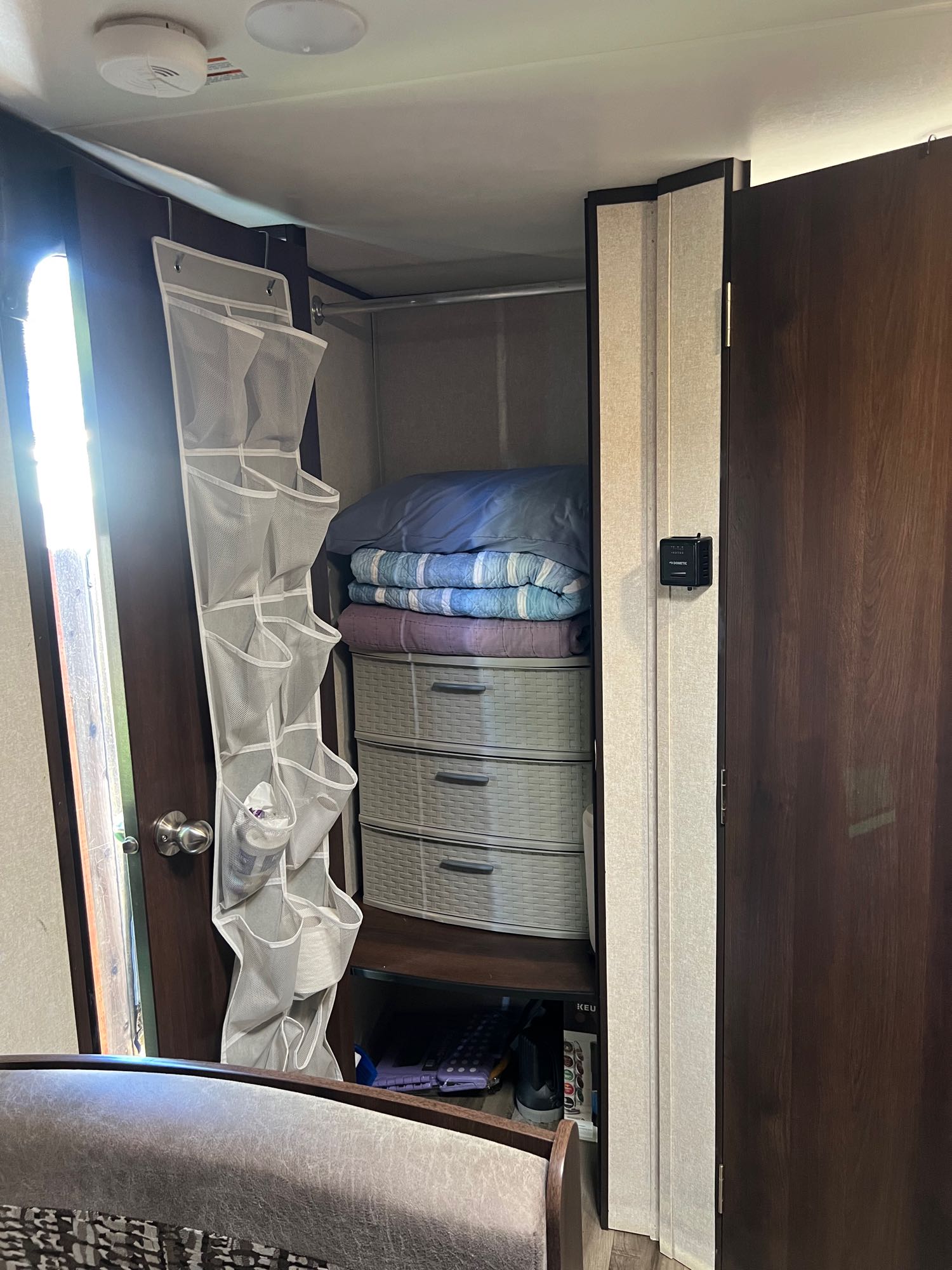 Maximizing space in this RV rental: an organized closet with blankets, basket drawers, and a hanging shoe organizer.. Jayco Jay Flight SLX 2020