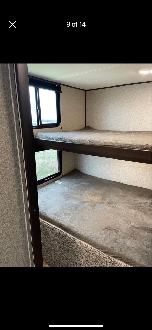RV rental interior features cozy bunk beds with windows, ideal for family travel.. Keystone RV Springdale 2019