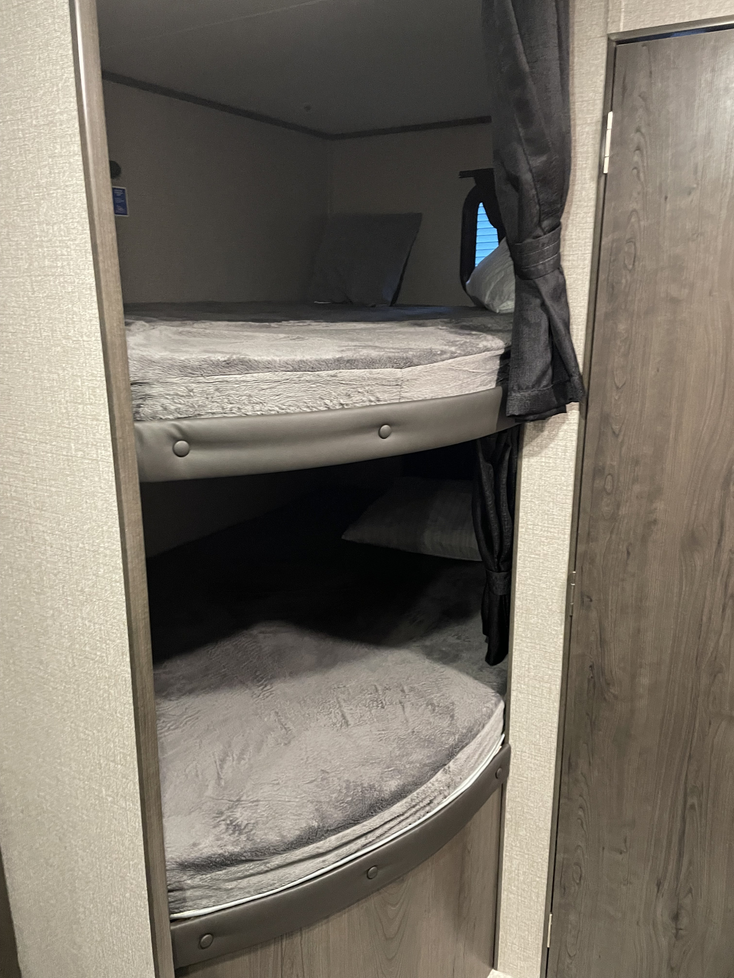 RV rental: Double bunk beds in a modern RV interior, offering comfortable sleeping quarters for travelers.. Jayco Jay Flight SLX 2020