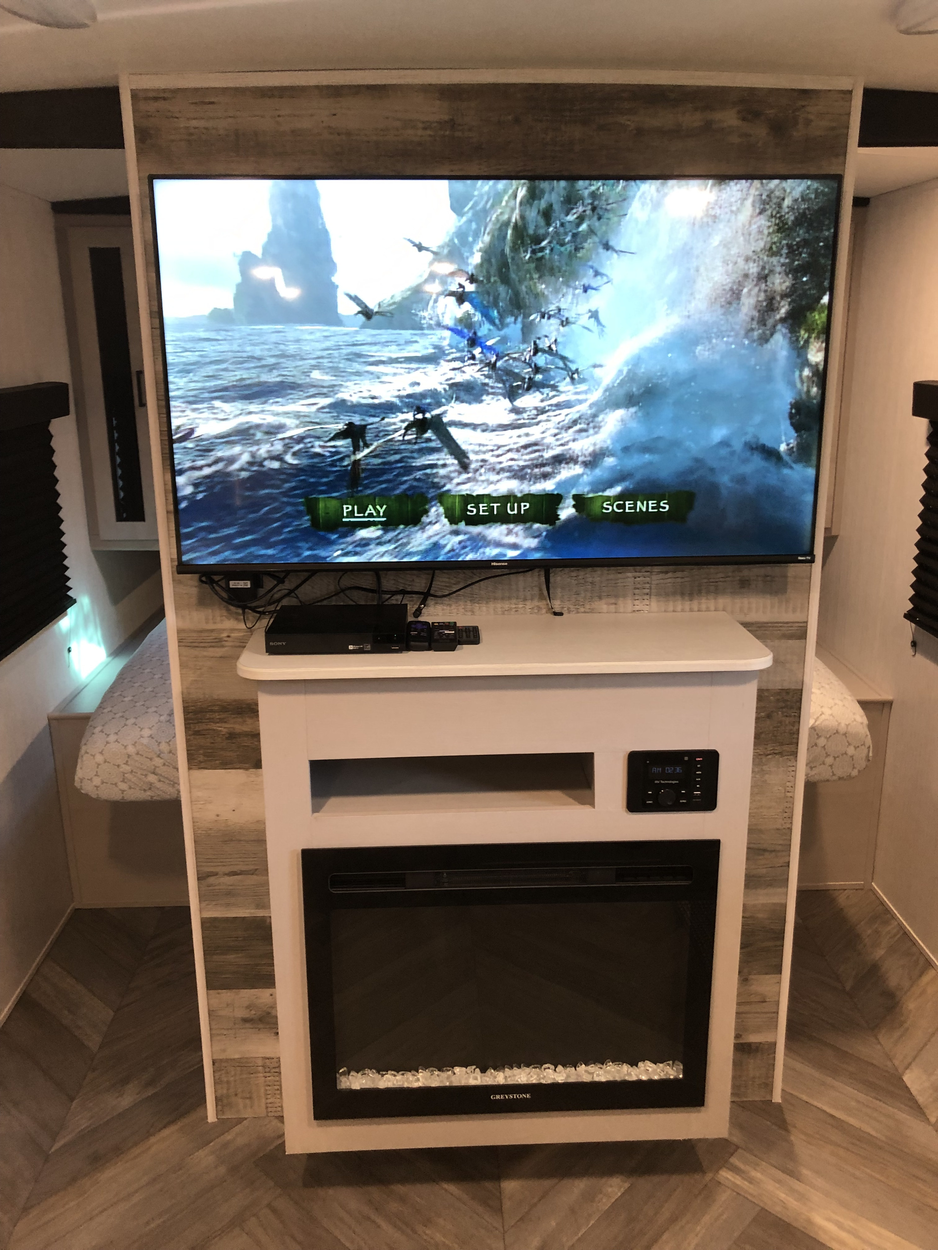 RV rental: Cozy entertainment area featuring a large TV, Sony media player, built-in control panel, and a GREYSTONE electric fireplace.. Heartland RVs Mallard 2023