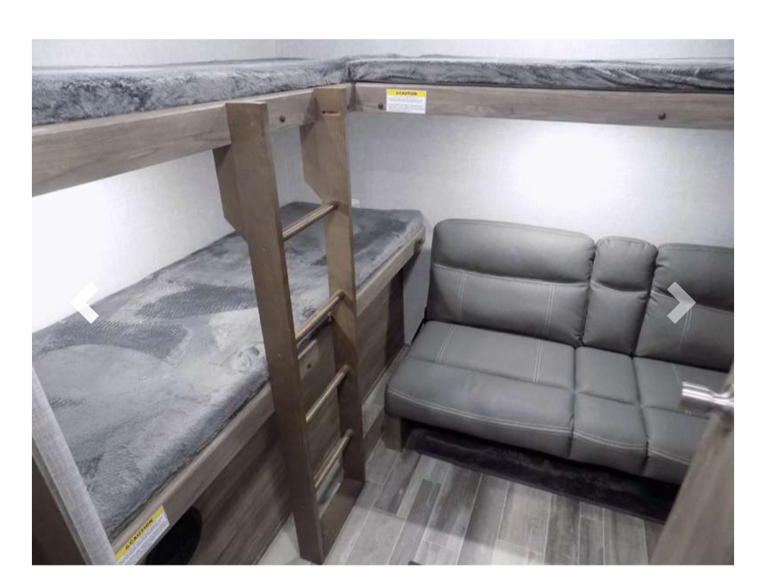 RV rental: The interior features two cozy bunk beds with a ladder, adjacent to a comfortable gray sofa, offering compact sleeping and seating.. Crossroads RV Zinger 2022