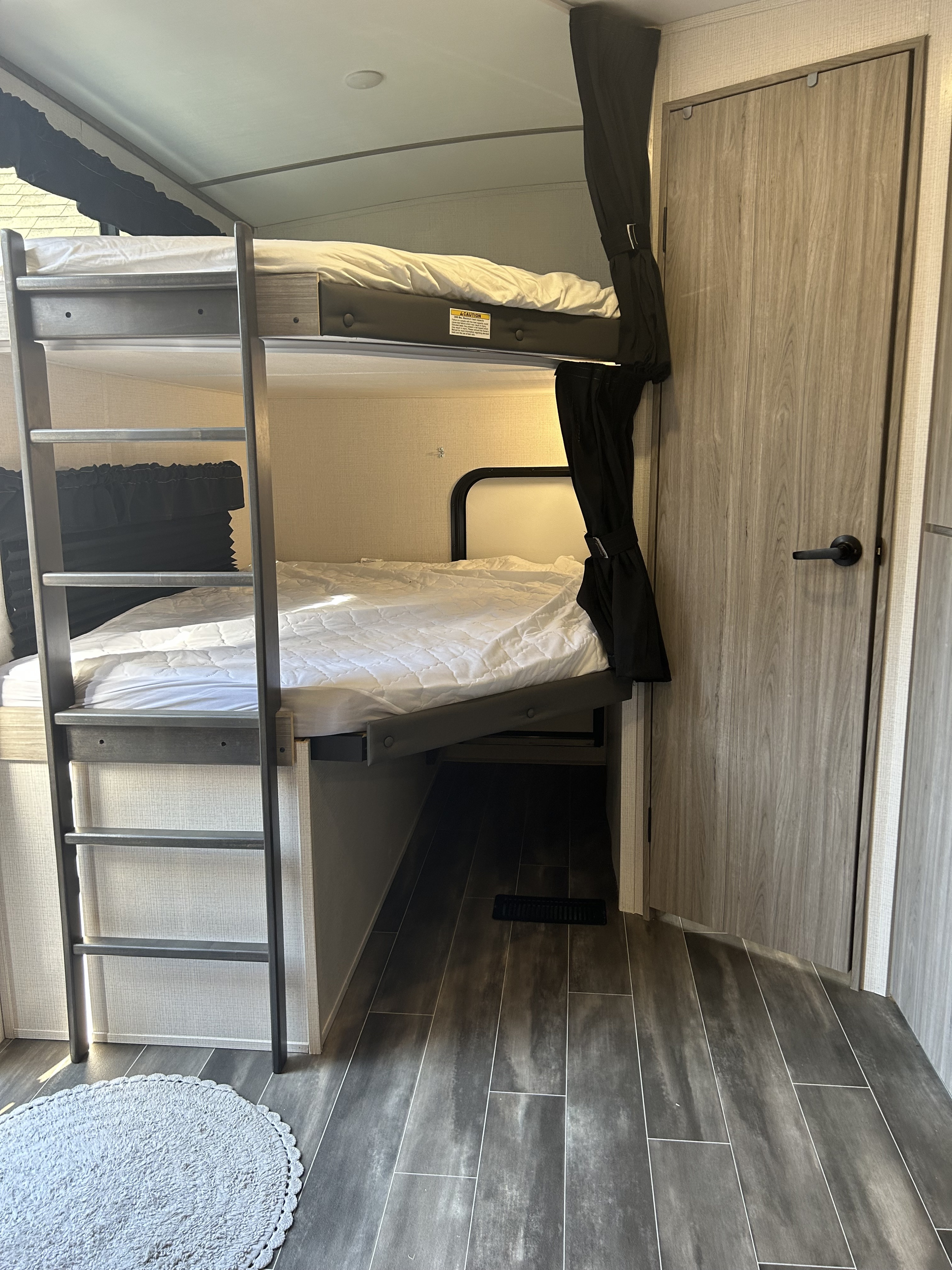 Two full sized beds. Bottom bunk folds up and has easy back door access for storage of bikes, toys, coolers, and luggage. . Keystone RV Passport GT 2022
