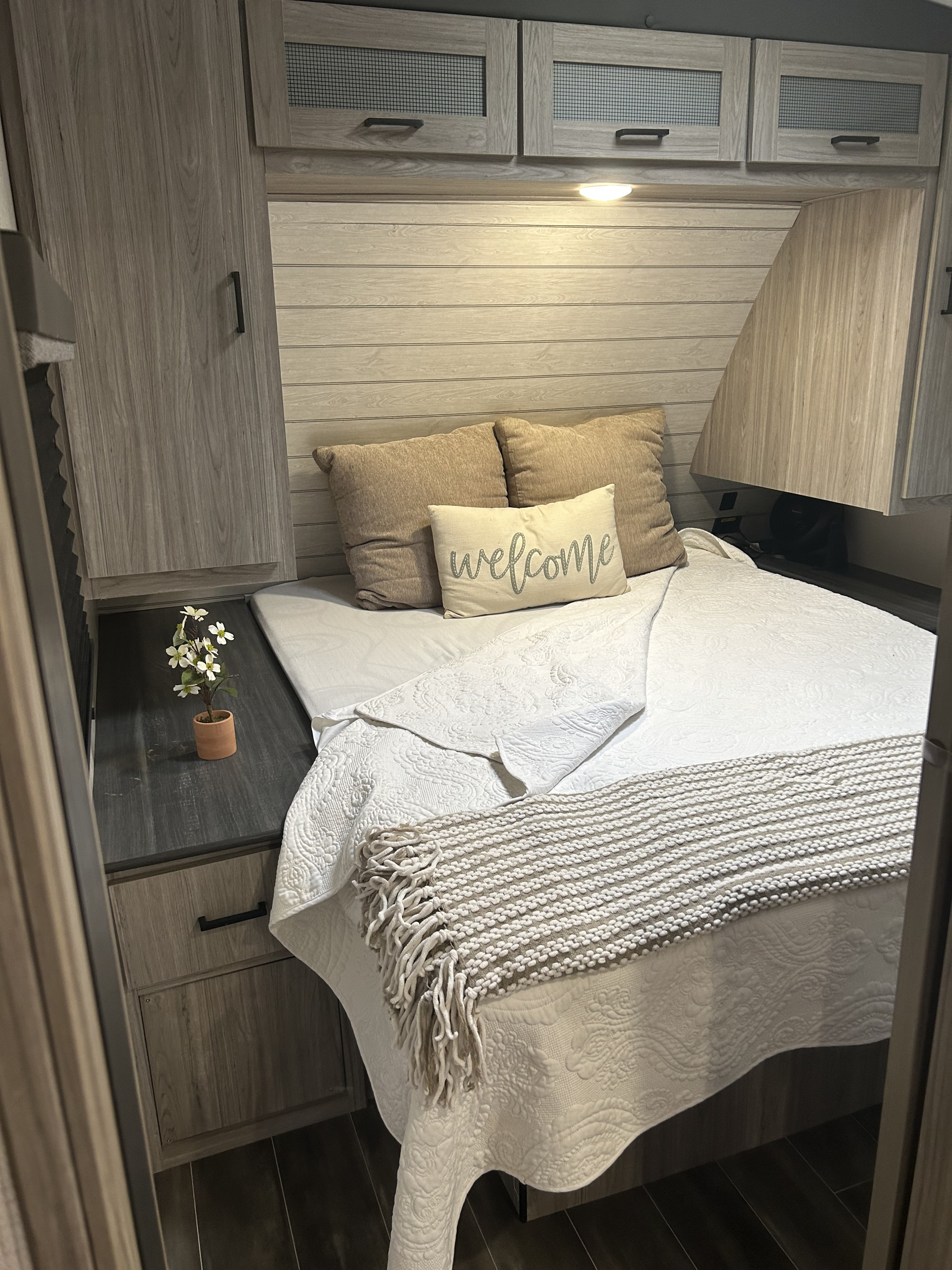 Bedroom has a sliding door for privacy and USB outlets on nightstand . Keystone RV Passport GT 2022