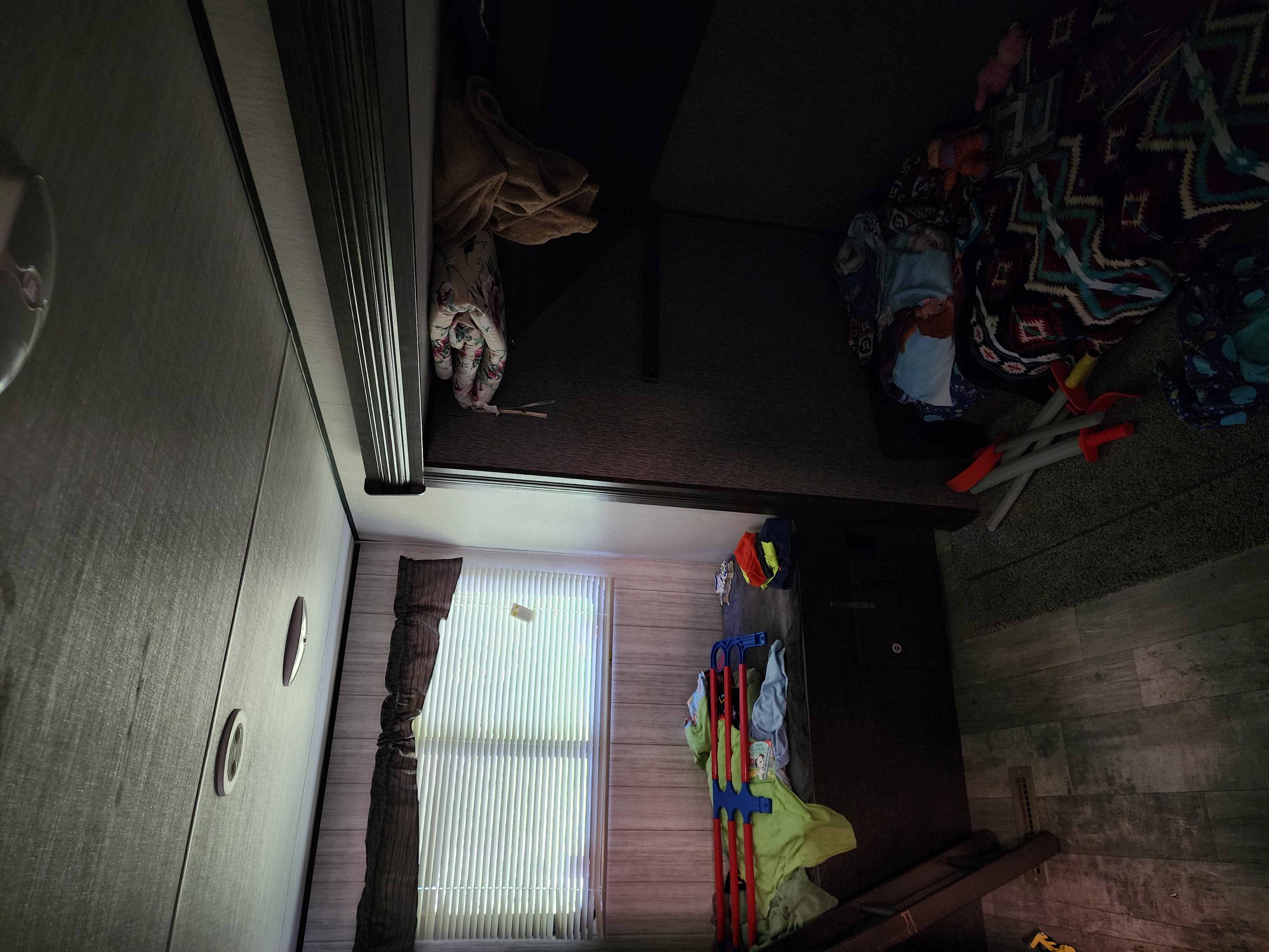 RV rental bedroom: a compact space with a raised bunk, window with blinds, and toys on the floor.. Heartland RVs Pioneer 2020