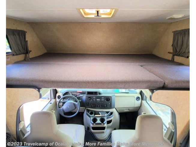 Interior of this RV rental shows the comfortable overhead bunk bed and the driver's cockpit.. Thor Motor Coach Four Winds Majestic 2015