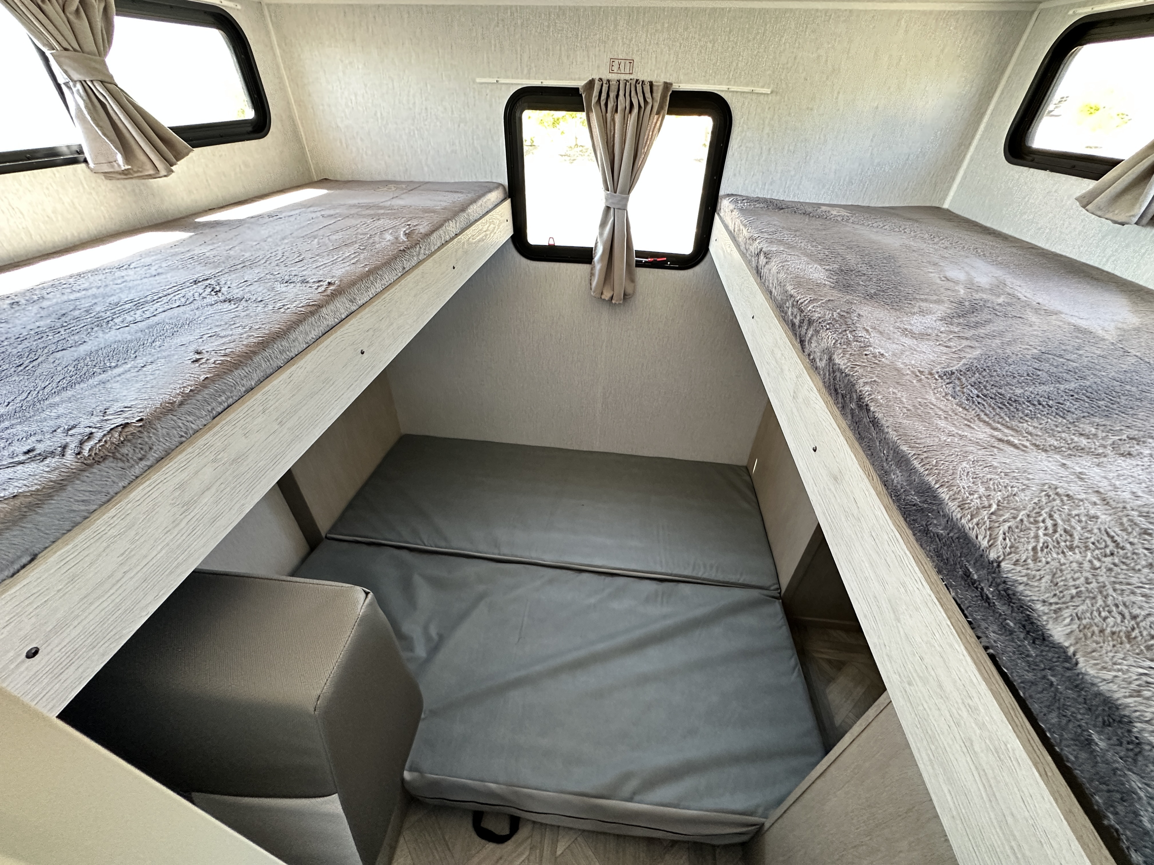RV rental: Inside, two upper bunks & a lower sleeping area with windows, a cozy setup for travelers.. Forest River Salem Cruise Lite 2023