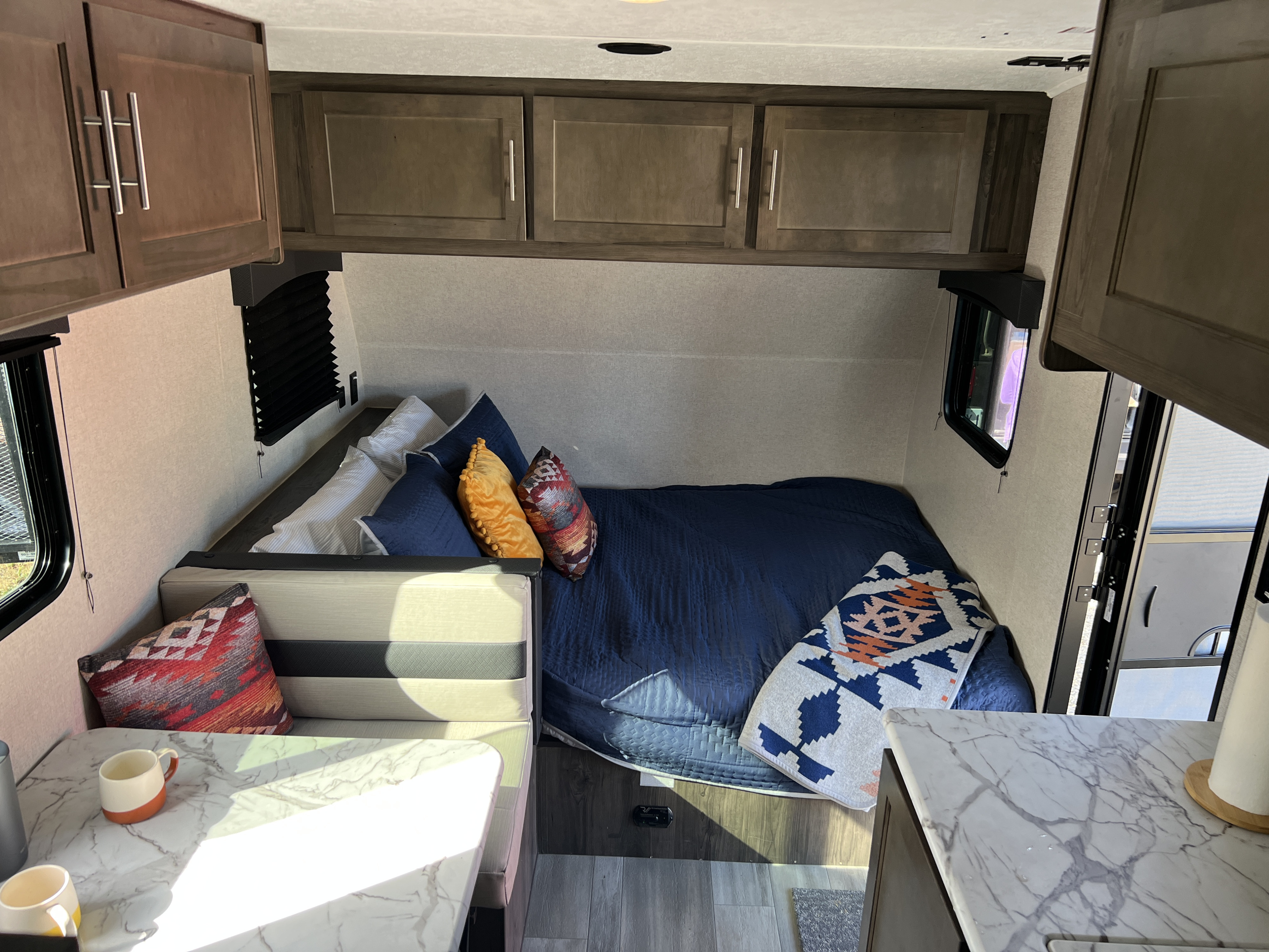 Cozy RV rental interior with bed, dinette, and modern kitchen area, perfect for travel adventures.. Clipper Clipper Trailer 2021