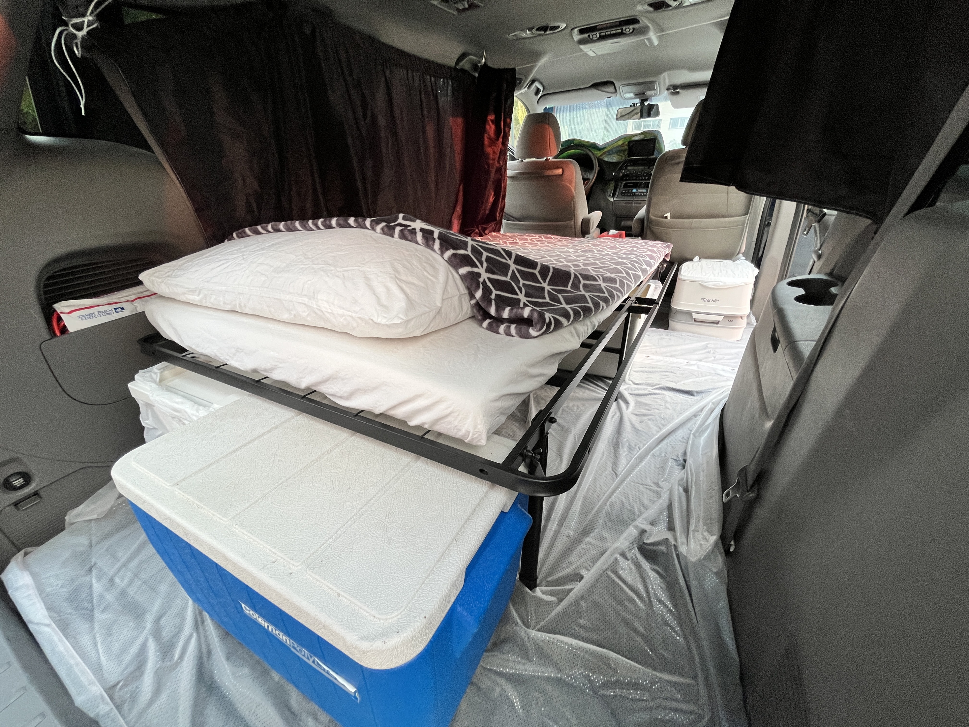 RV rental alternative: minivan setup with bed, cooler, privacy curtains, & portable toilet for camping.. Honda Odyssey 2010