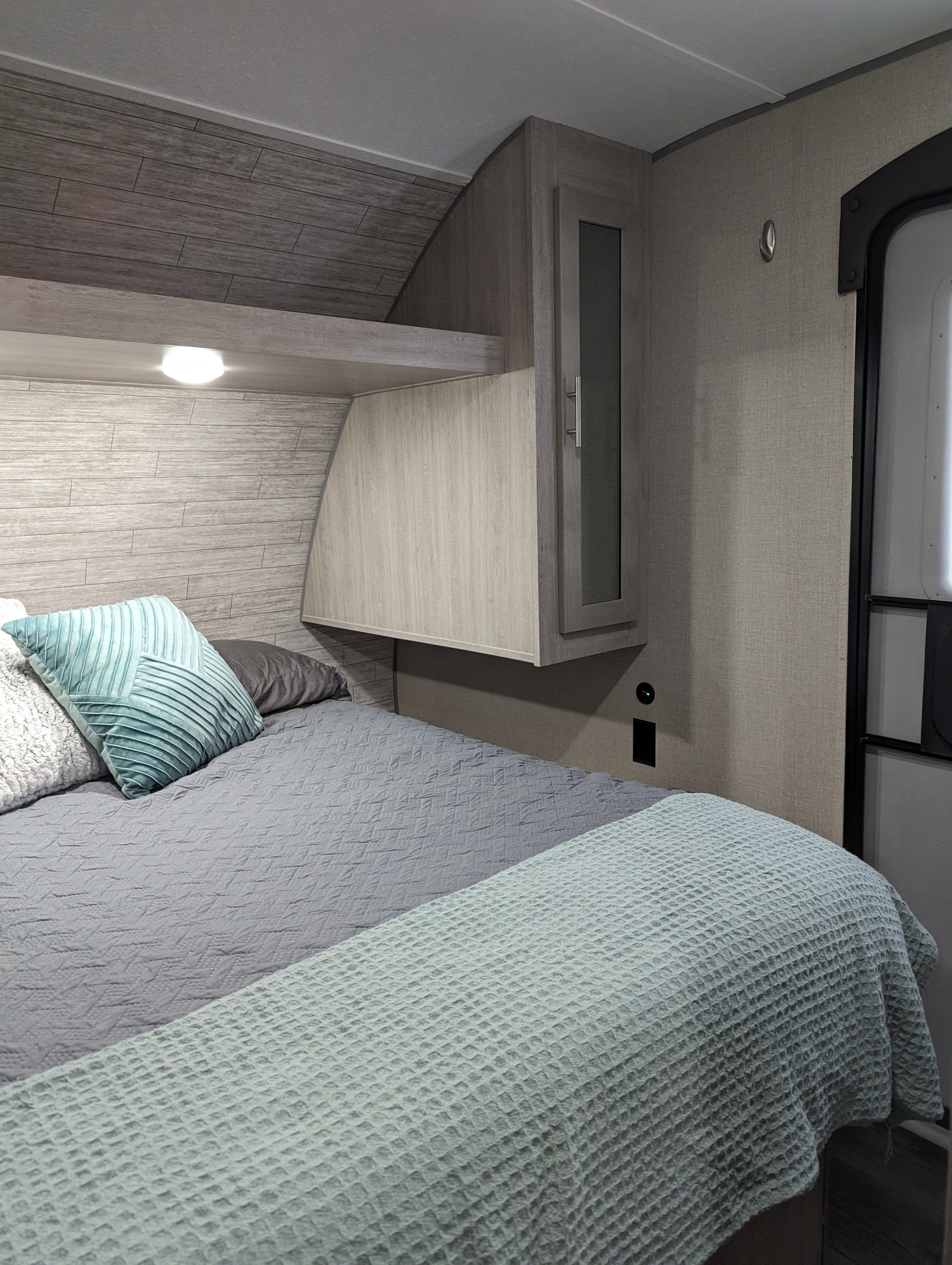 RV rental: Comfortable bedroom featuring light wood interiors, plush bedding, and convenient overhead storage.. Coachmen Catalina Summit 271DBS 2023