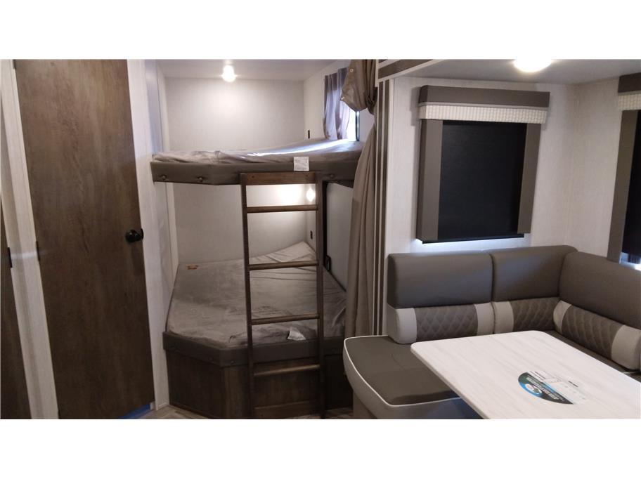 RV rental interior featuring cozy bunk beds with a ladder and a functional dinette area with a table.. Forest River Salem 2022