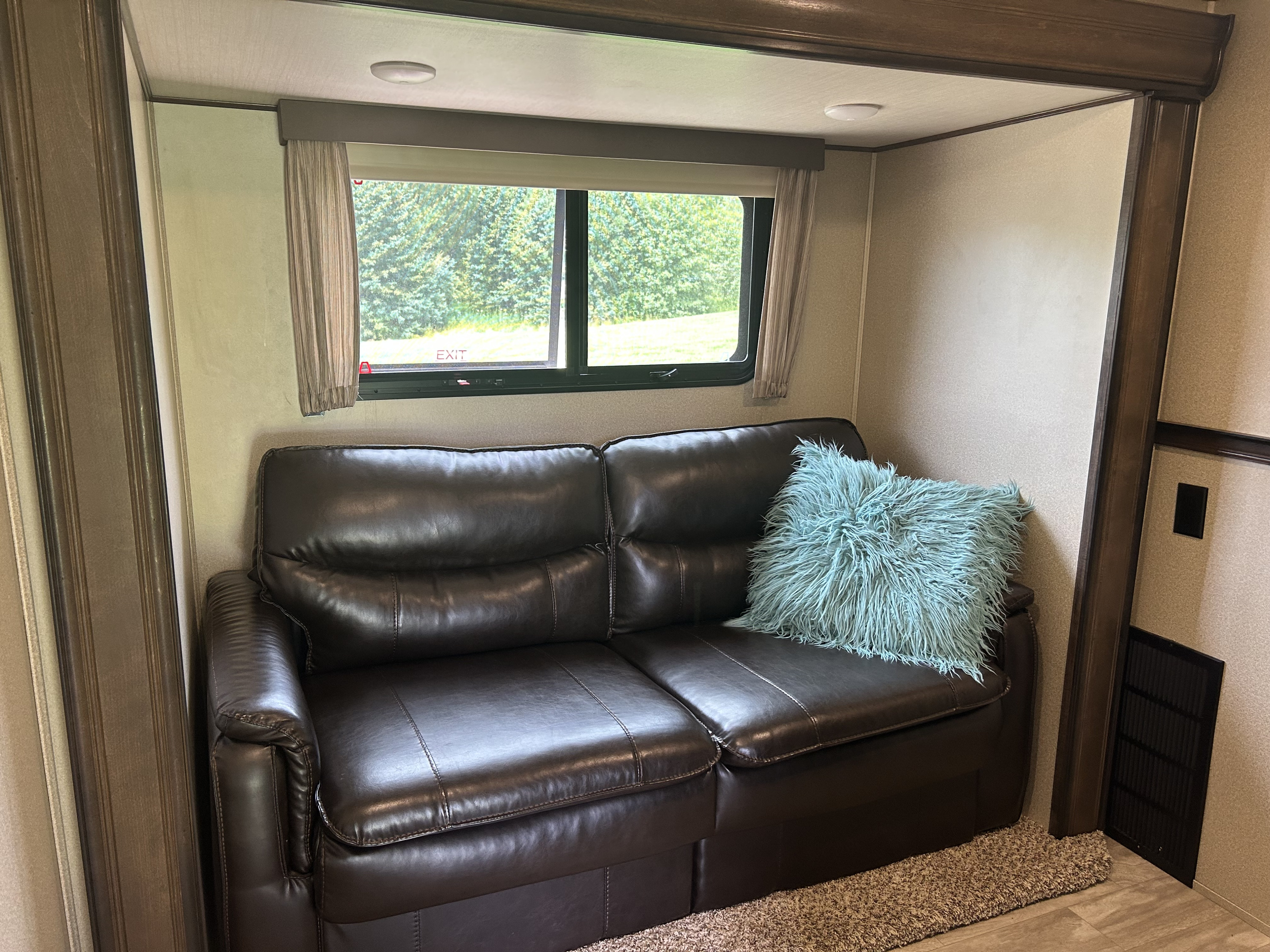 bunkroom with leather queen pull-out sofa. Grand Design Solitude 2018
