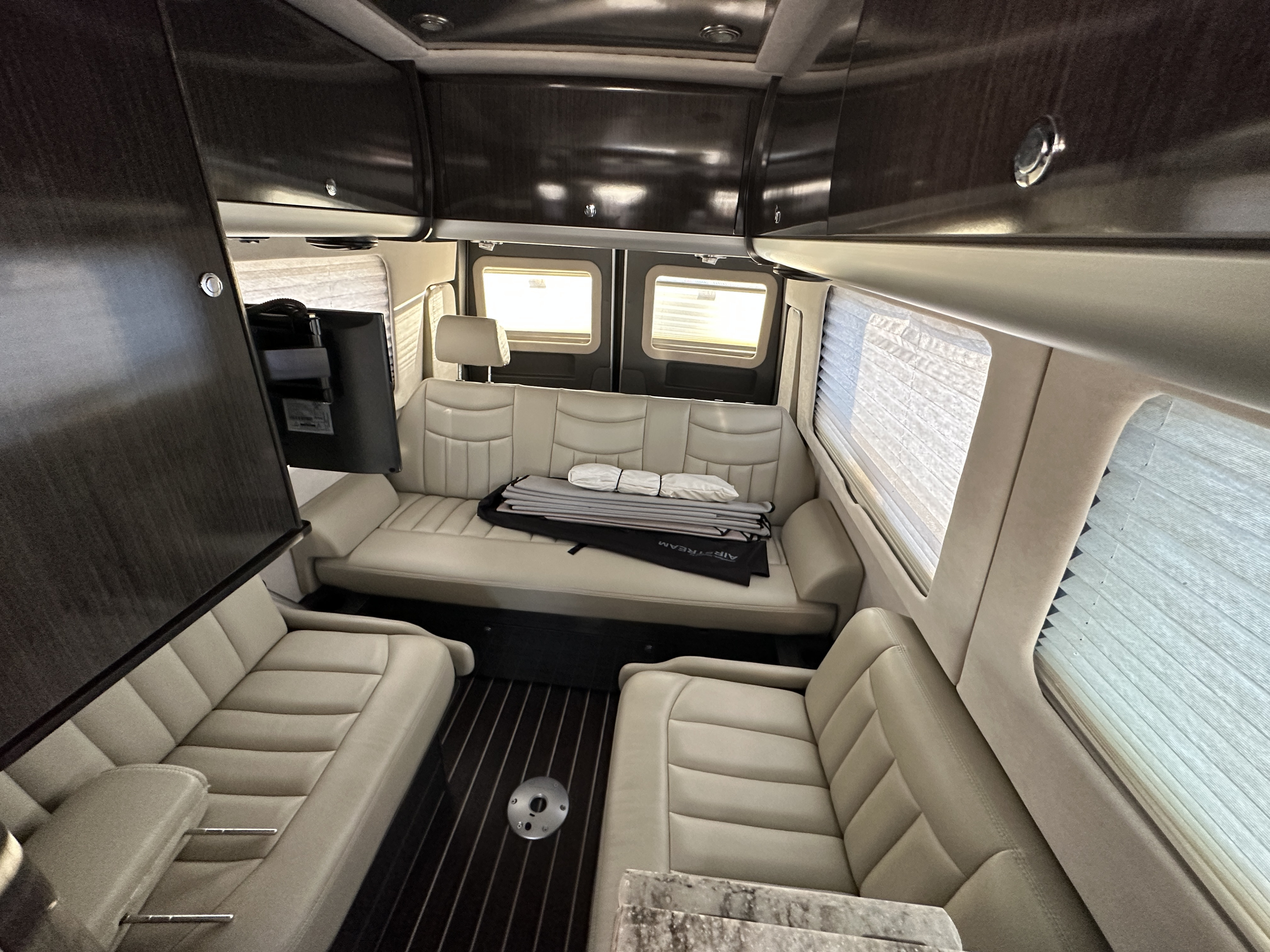 These 3 seats covert into one large King size bed that is a soft breathable material.  4 seat belts . Airstream Interstate 2014