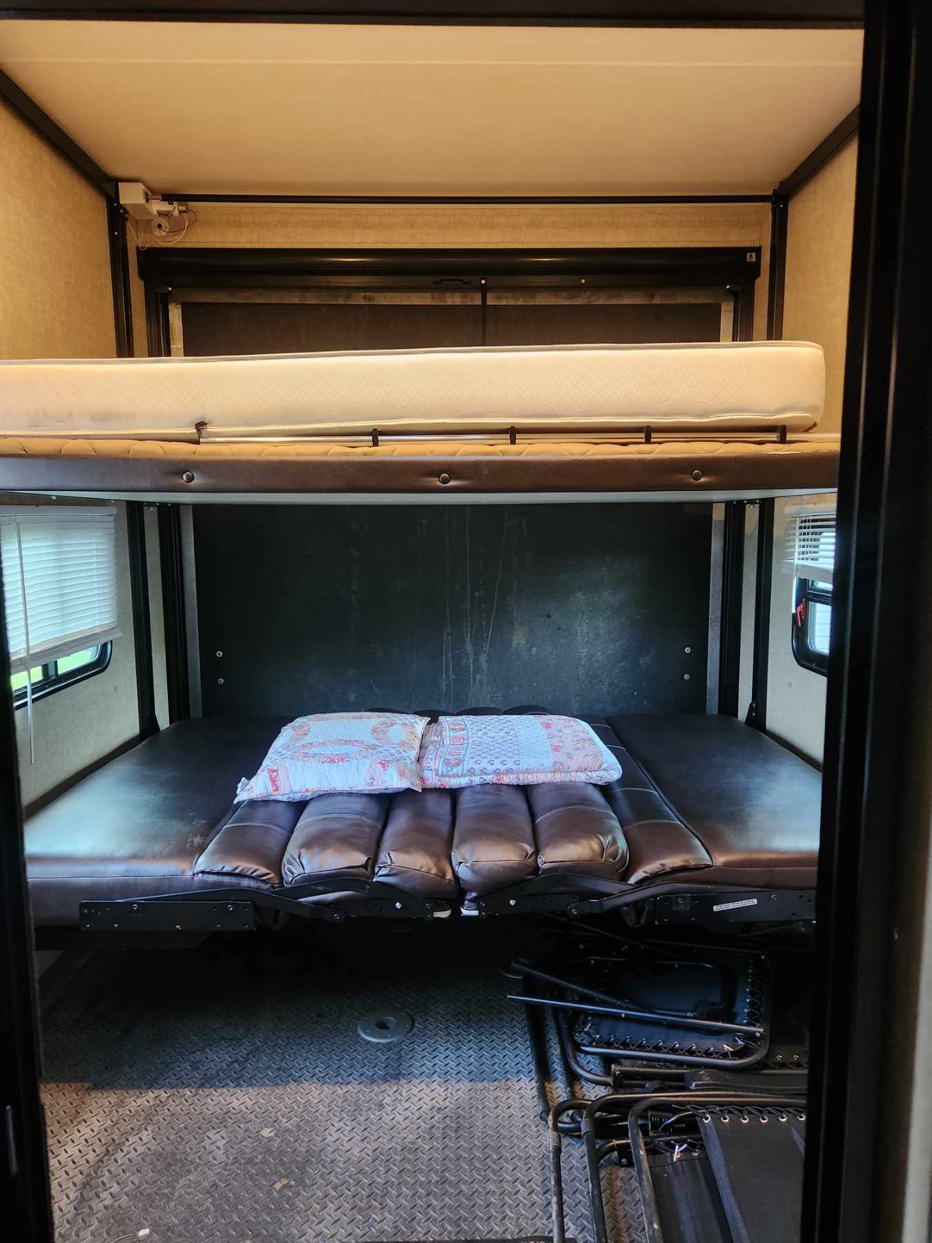 RV rental interior: Versatile toy hauler with bunk beds, sofa bed, and durable flooring for comfortable stays.. Heartland Torque 2015