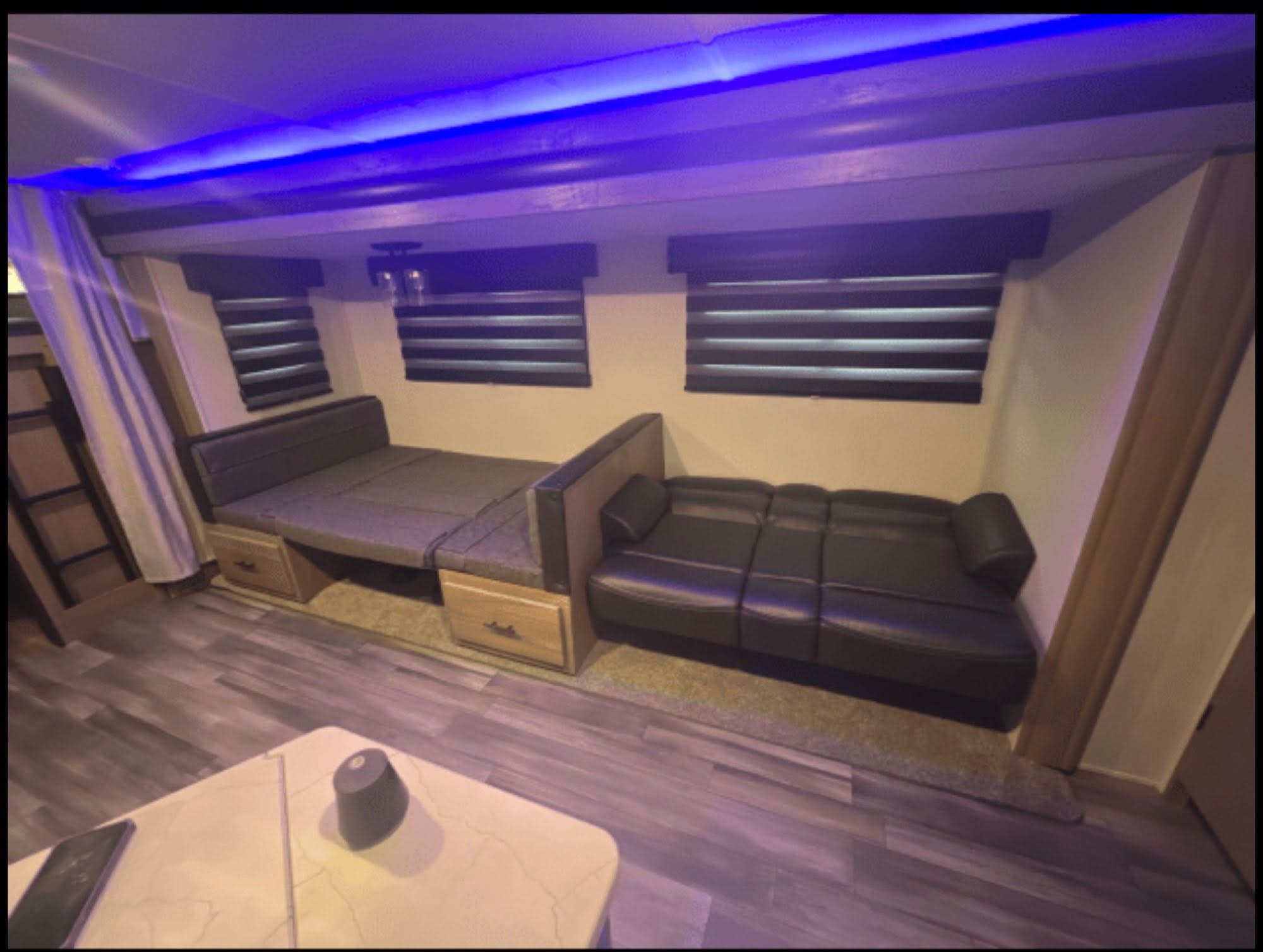 This rv rental features a modern interior with blue LED lights, convertible sofas, and a ladder to bunks.. Forest River Alpha Wolf 26-DBH-L 2023