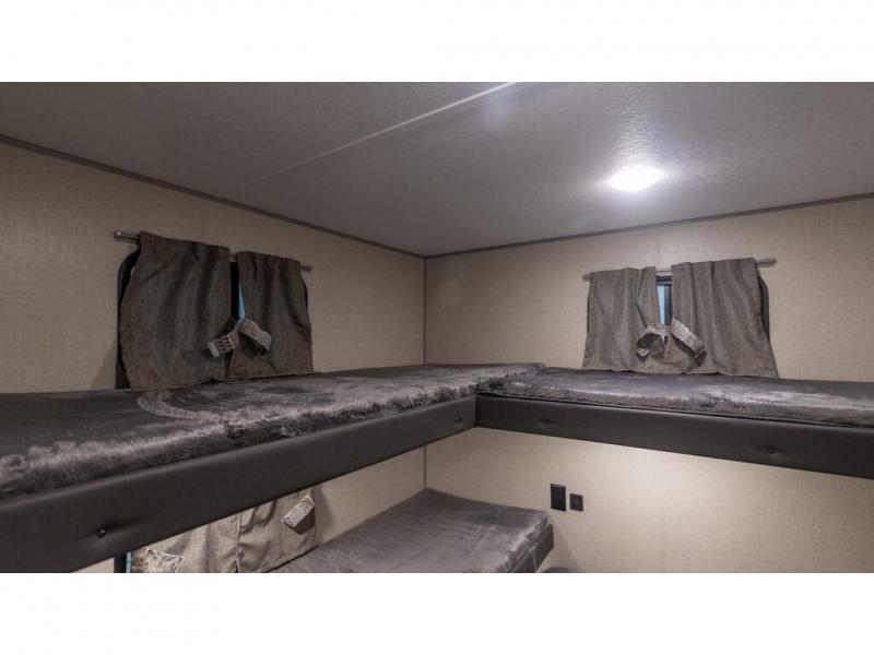 RV rental interior with multiple bunk beds, offering a cozy sleeping area for your travel adventures.. Forest River Coachmen Catalina Legacy 2022