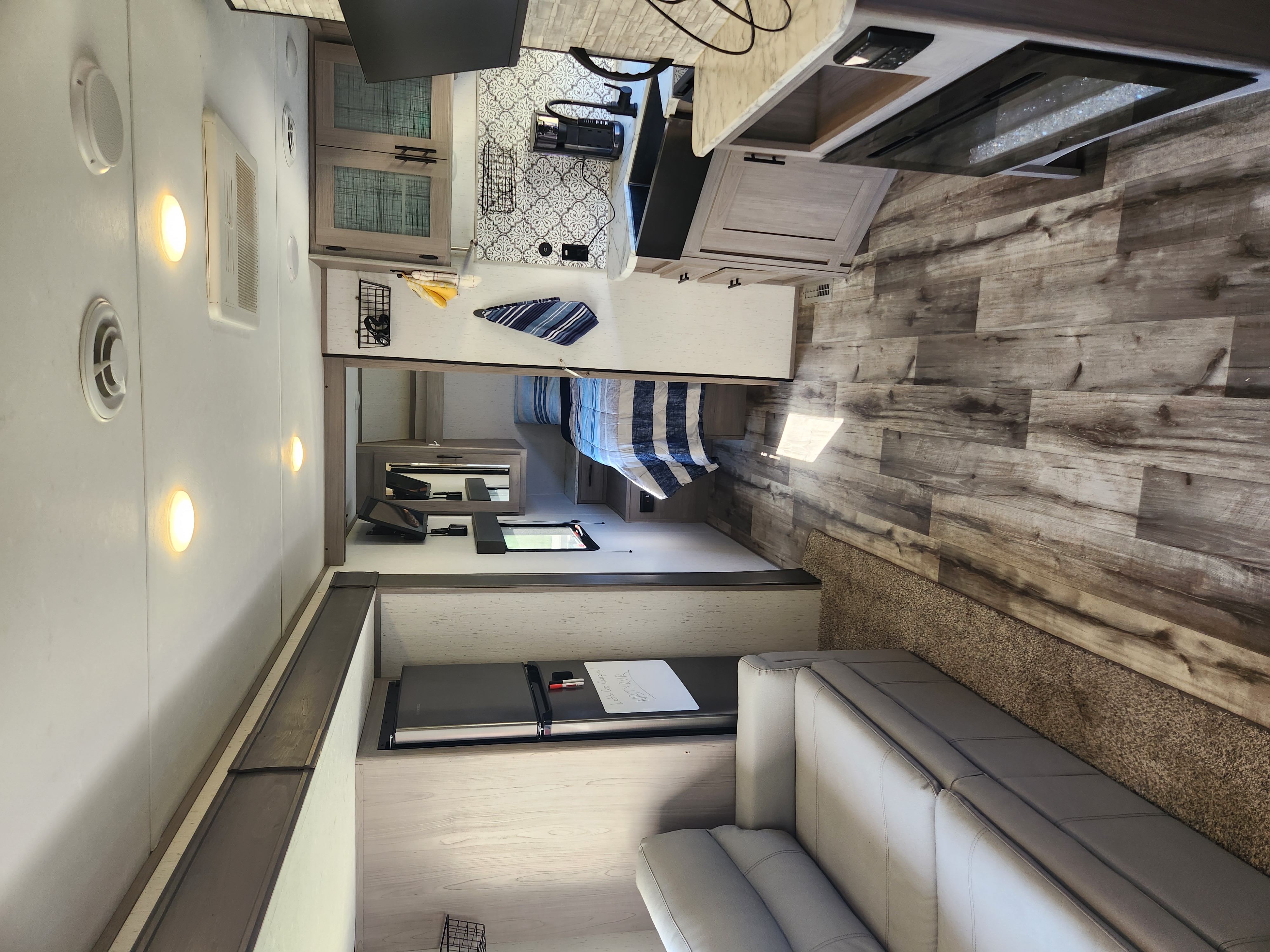 Step inside this modern RV rental! Features a sleek kitchen, cozy bedroom, and comfortable living area with wood-look floors.. Dutchmen Coleman 2022