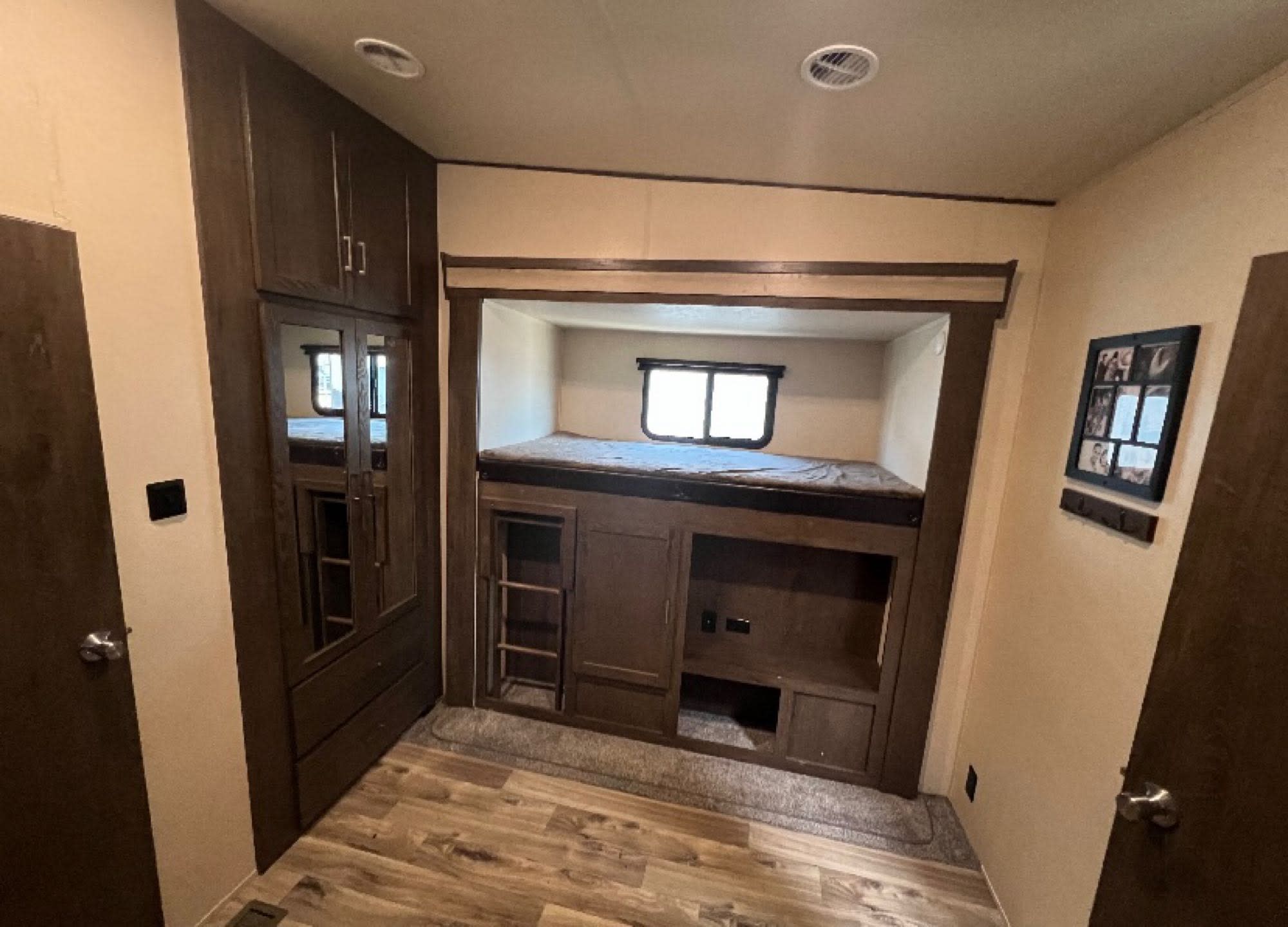 Spacious RV rental bunkhouse with comfortable bunk beds, ample storage, and a wardrobe. Ideal for family adventures.. Forest River Salem Hemisphere GLX 2019