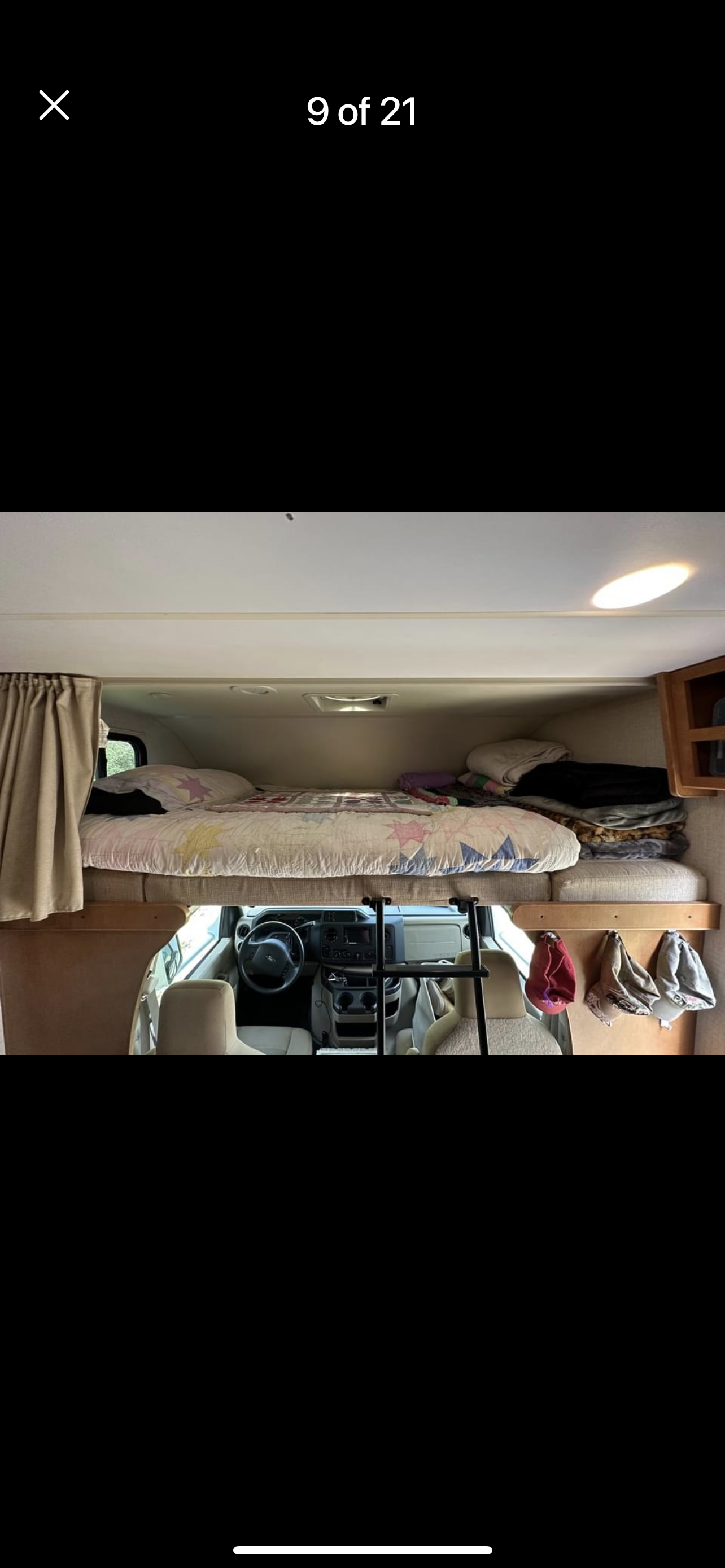 Cozy cab-over bunk and driver's area in this RV rental. Features a comfortable bed, ladder. Winnebago Minnie Winnie 2017
