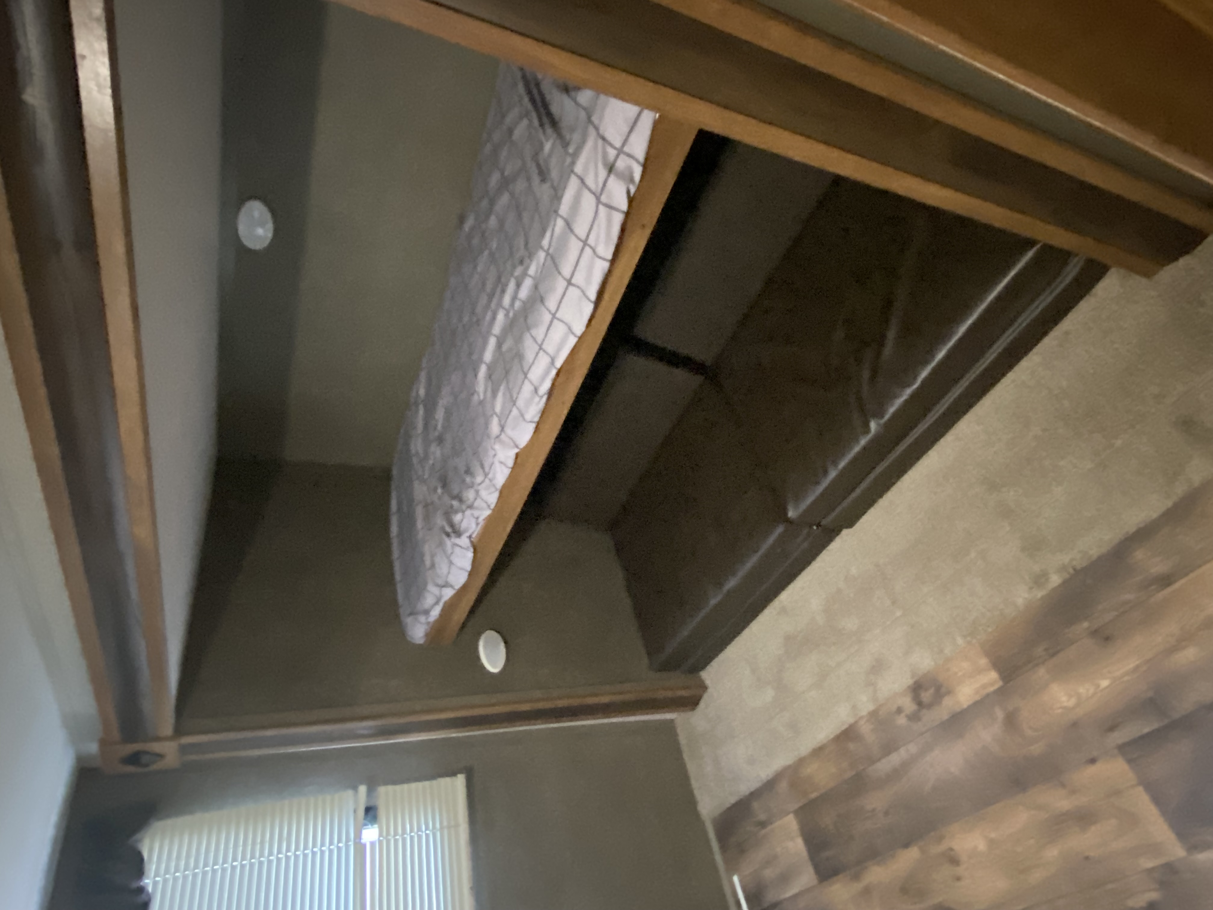 RV rental: Interior features a bunk bed above a dark sofa, wood floor, and ceiling accents.. Keystone RV Springdale 2017