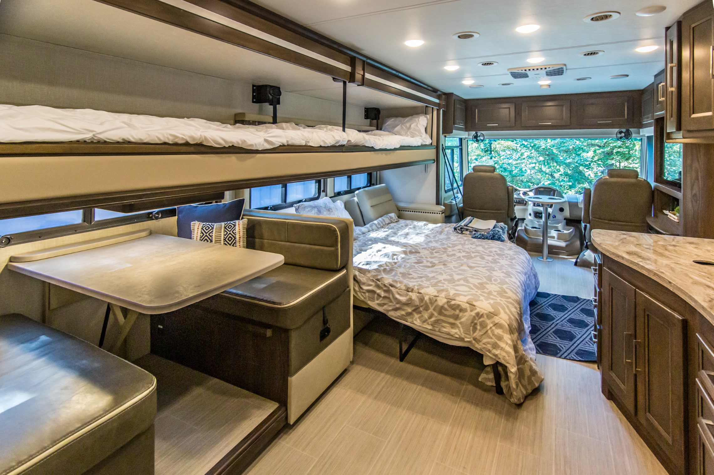 RV rental: Spacious interior featuring bunk beds, a dinette, and a large bed, offering comfort.. Coachmen Mirada 2020