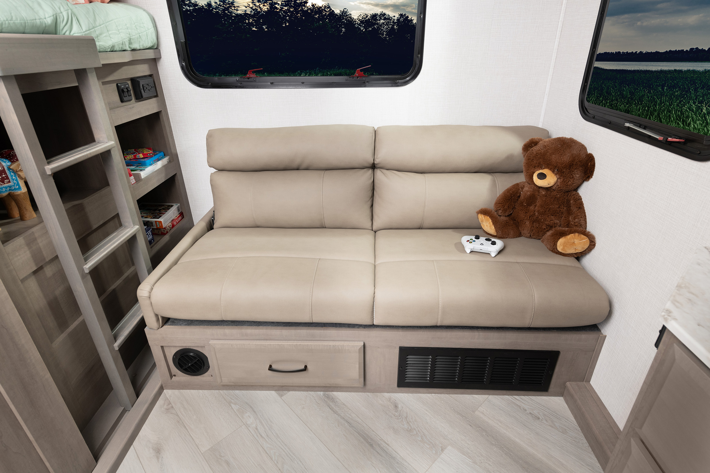 Cozy RV rental interior with bunk beds, a convertible sofa, gaming area, and ample storage.. Fleetwood Fortis 2024